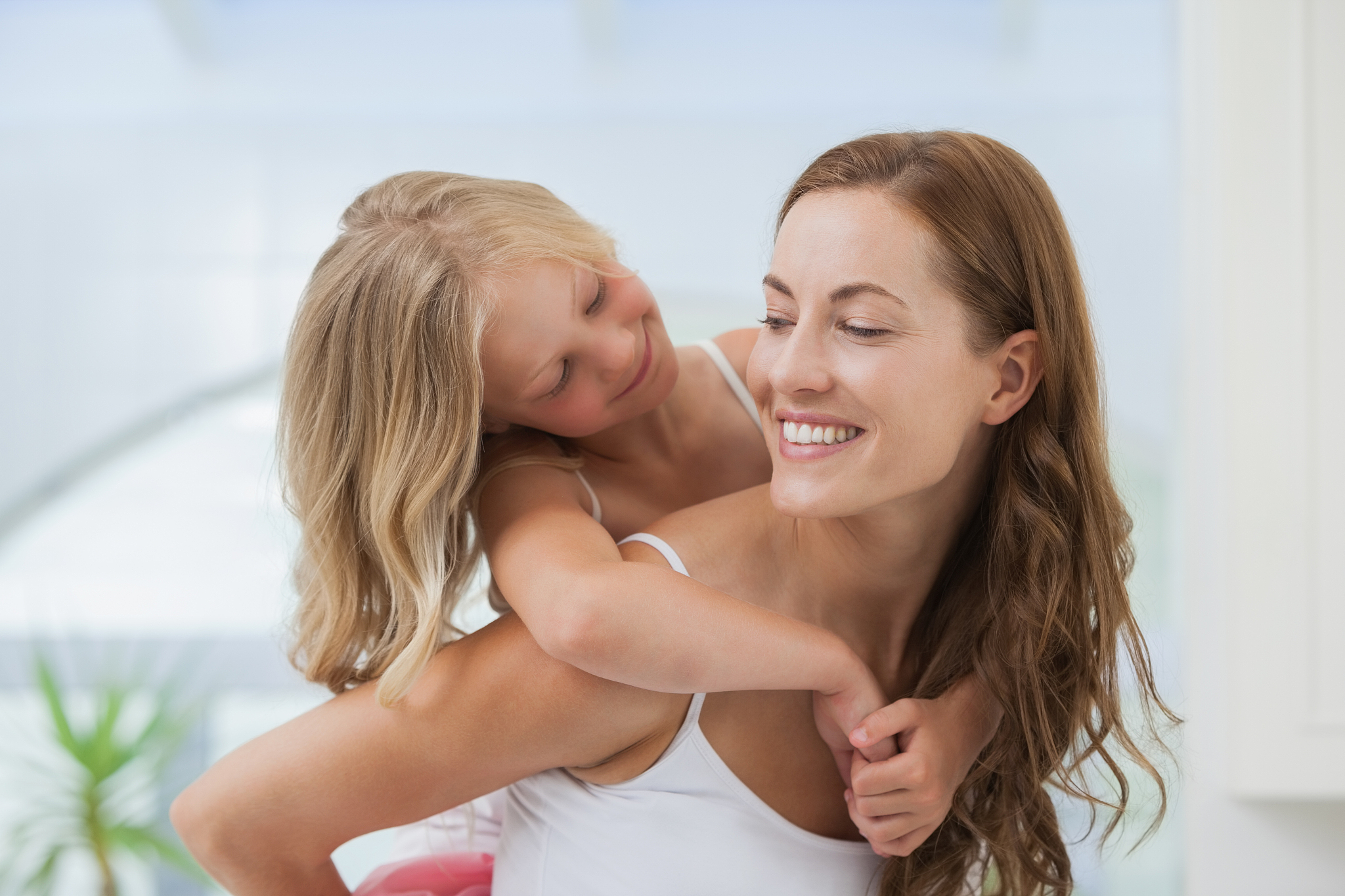 close-up of a happy woman carrying girl