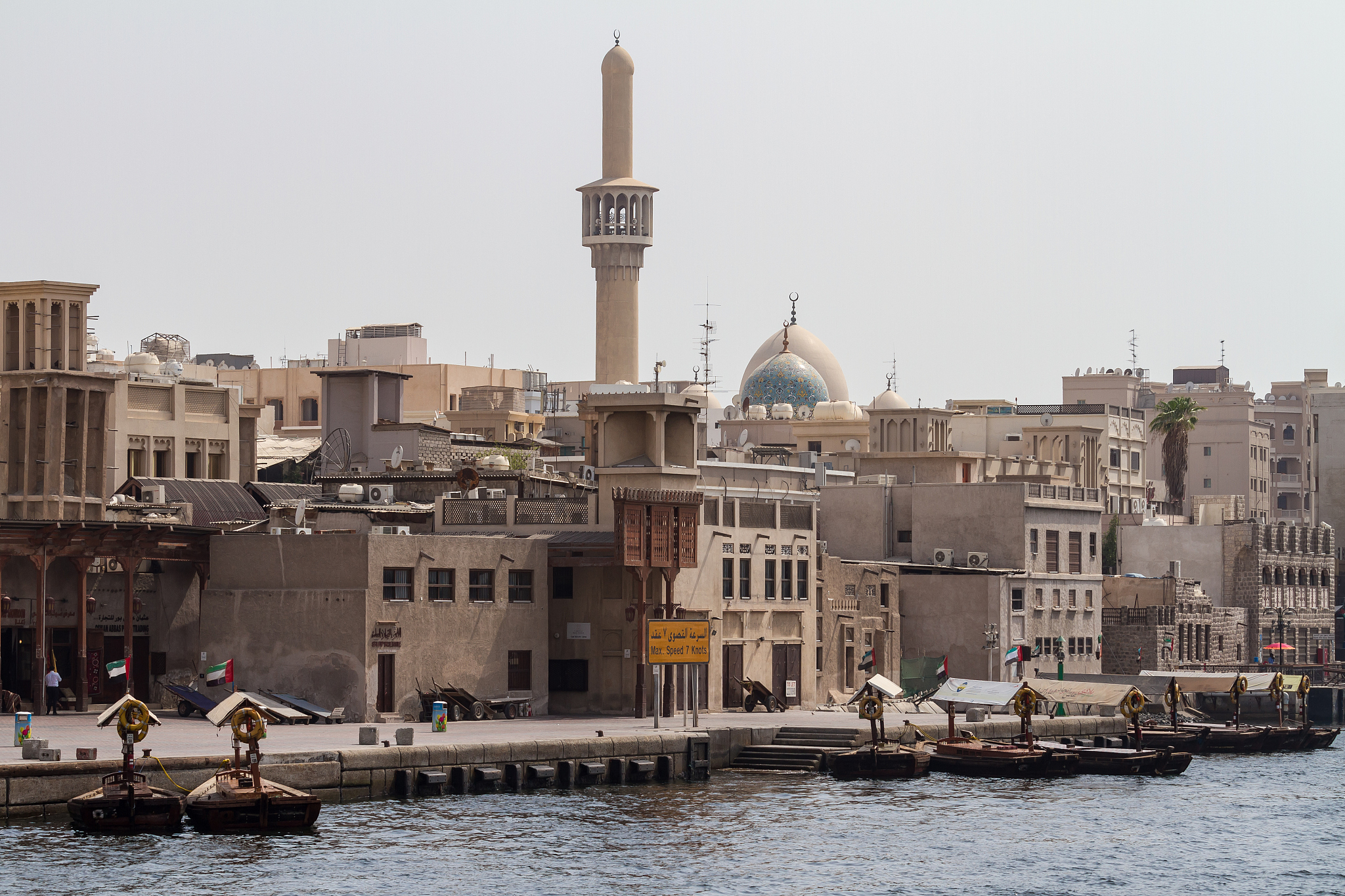 old dubai with mosque towers and river boats