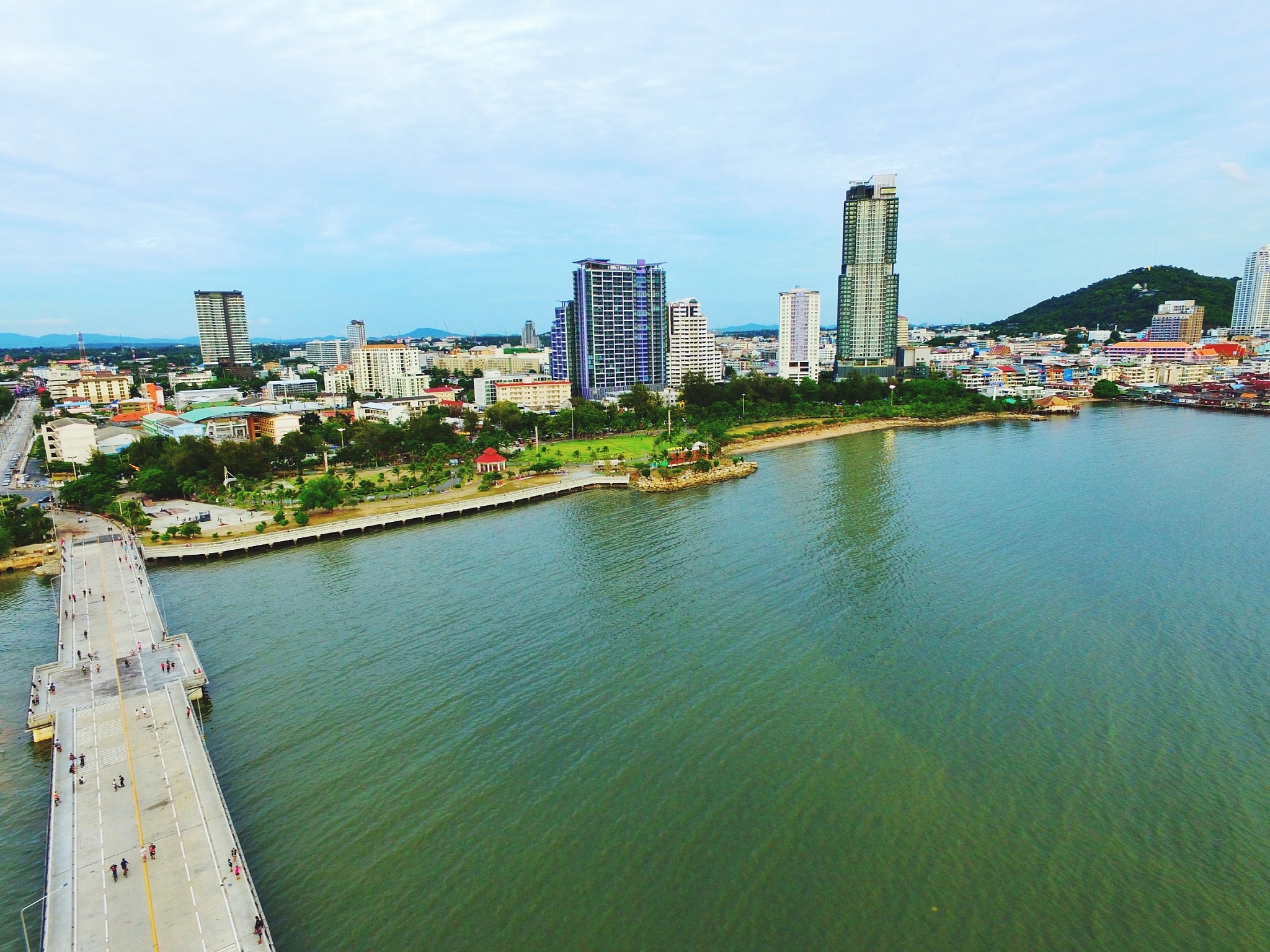 buildings by river against sky in city