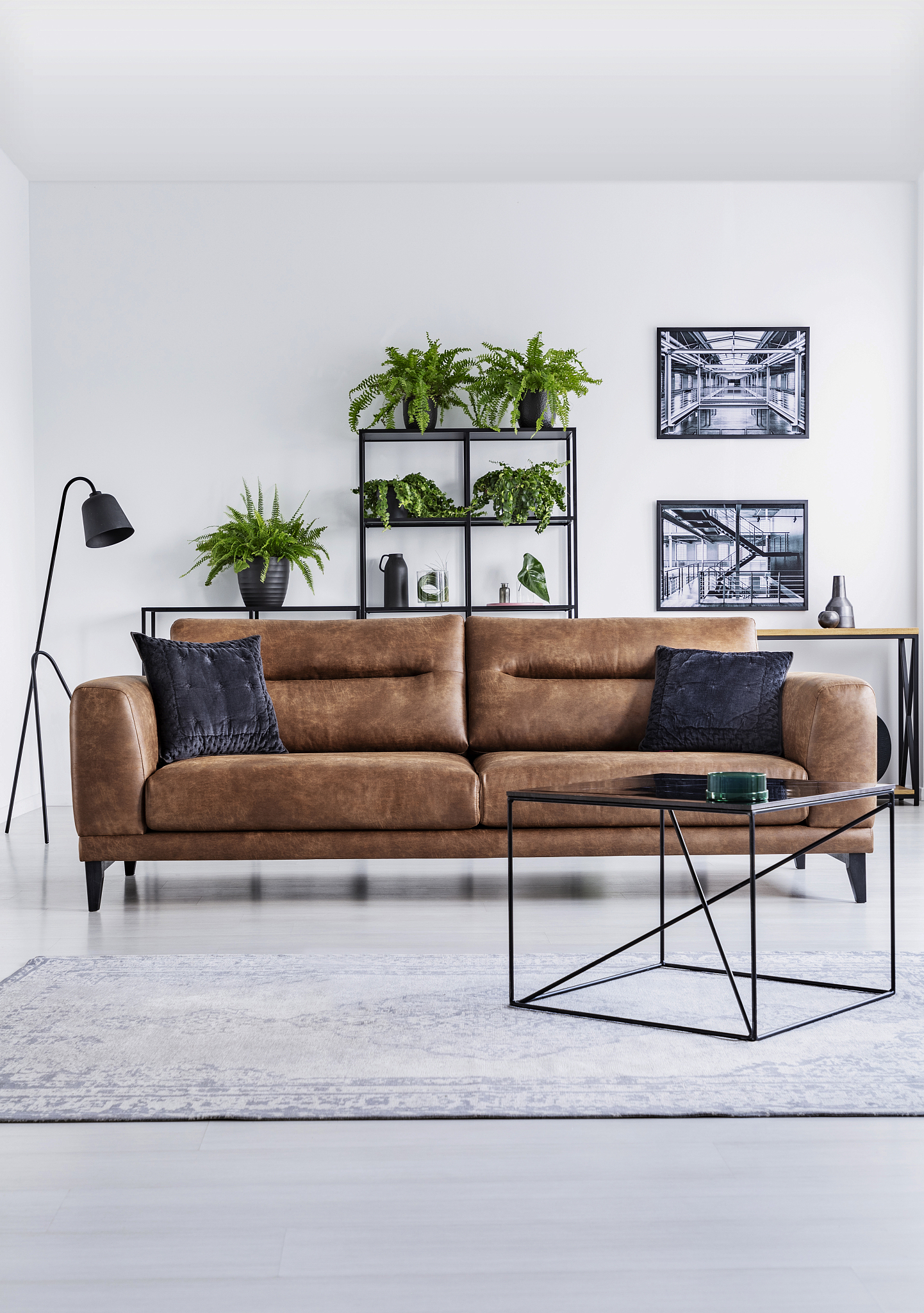 vertical view of luxury home interior. brown leather sofa with b