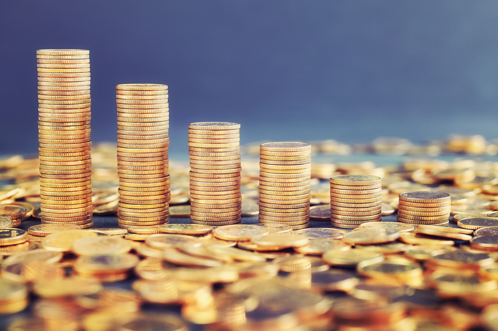 stacks of golden coins arranged as a chart.
