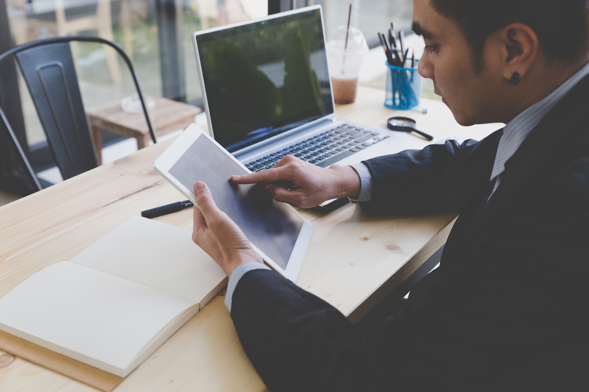 man using digital tablet on table