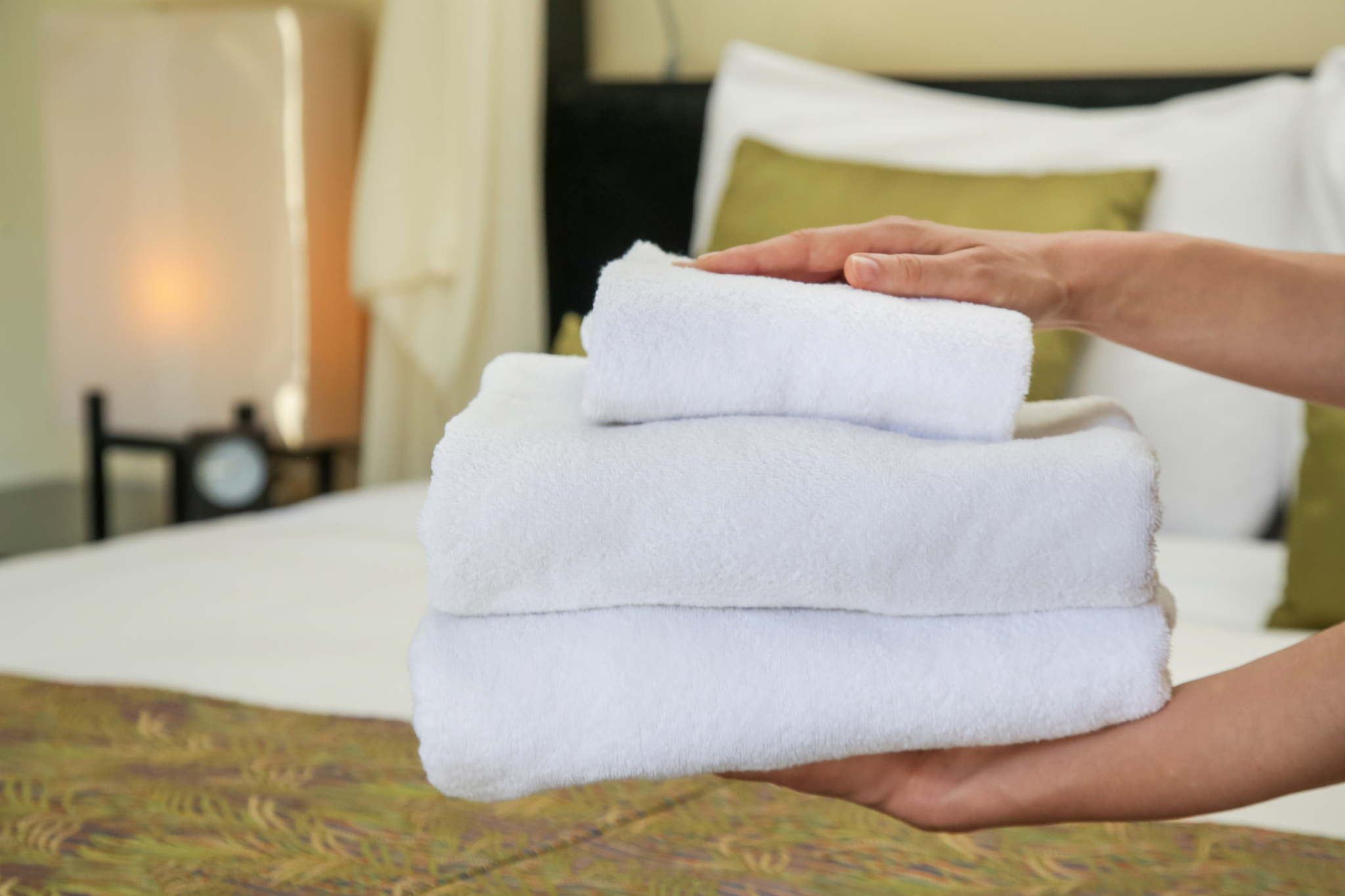 room service. woman changing towels in hotel room. housecleaner 