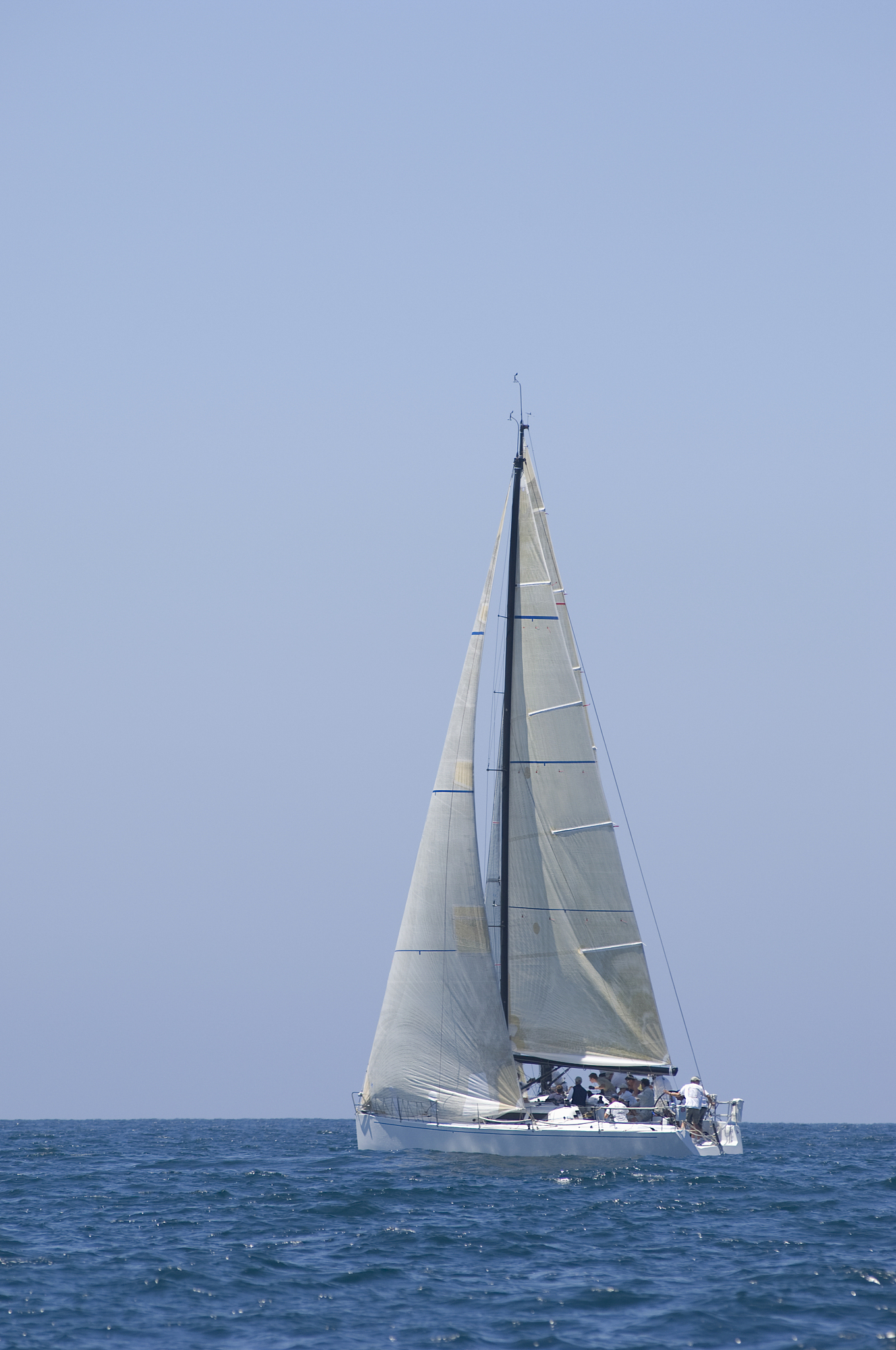 sailboat racing in the blue ocean against sky
