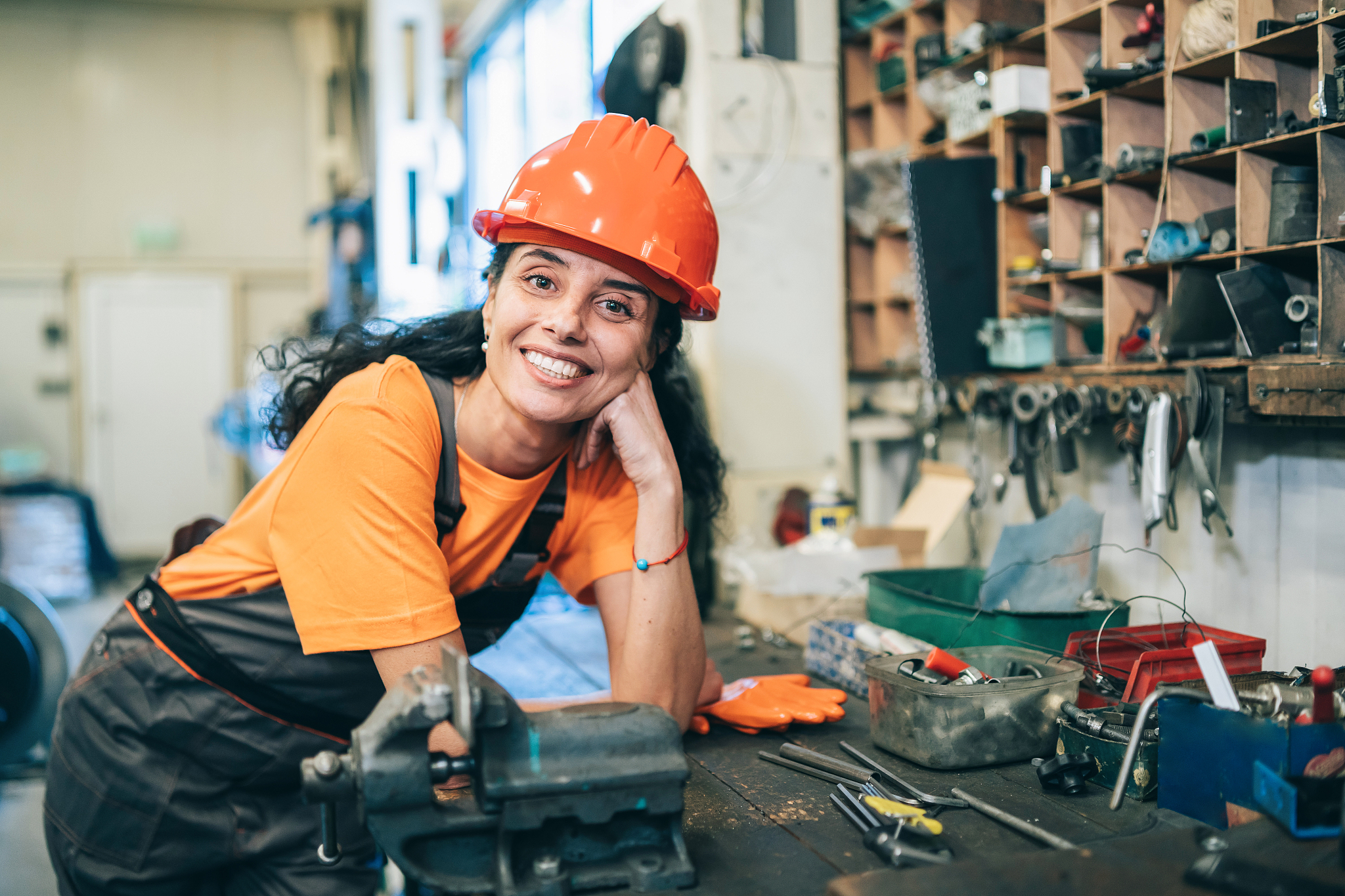 smiling female worker standing in workshop