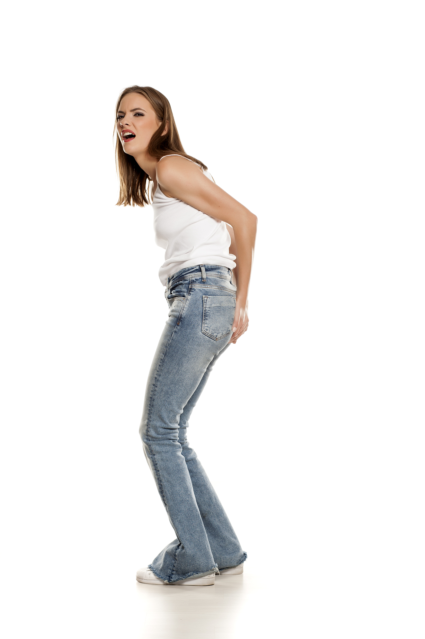 unappy young pretty woman needs a toilet on white background