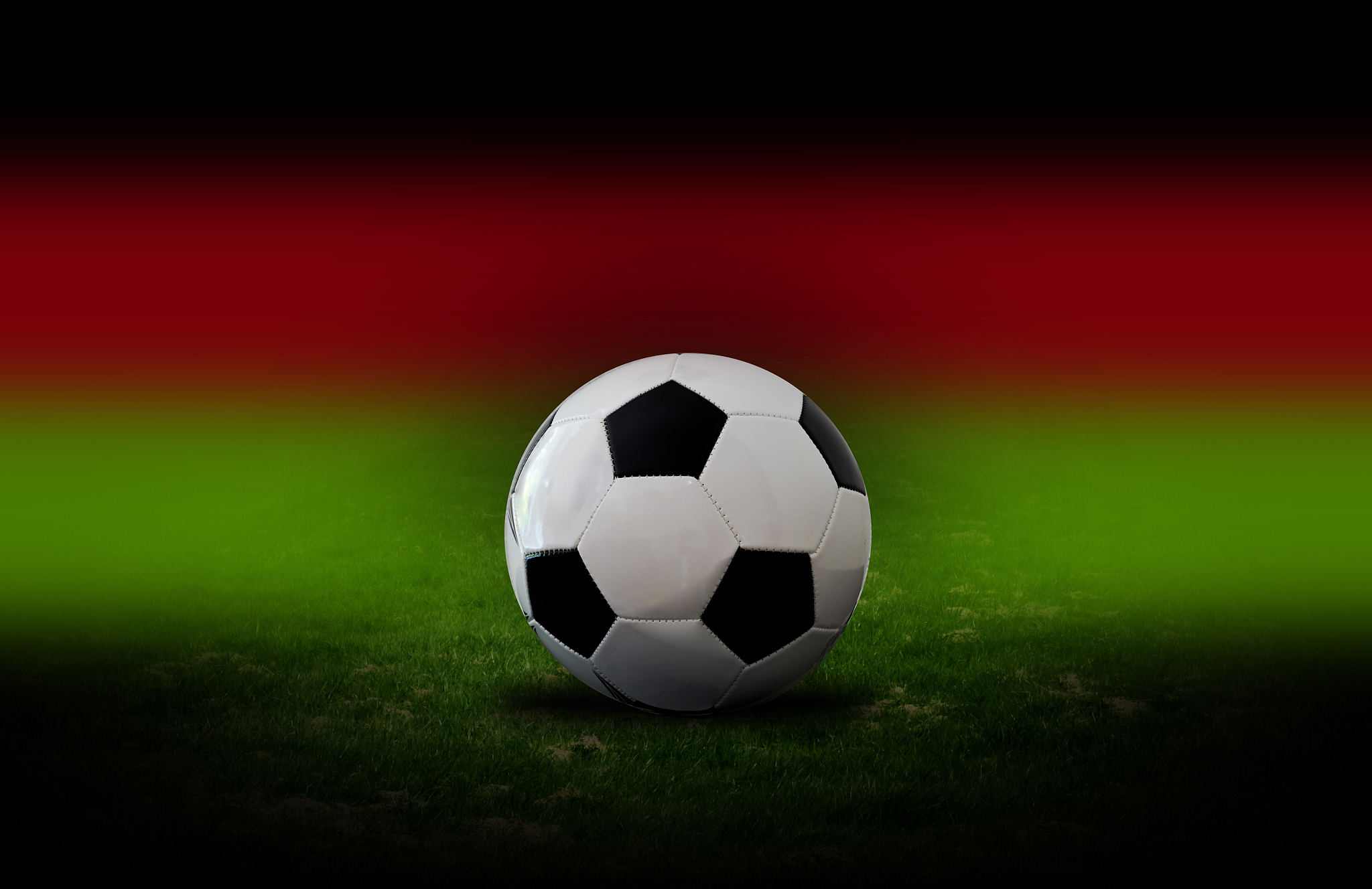 a football on the grass of a stadium.