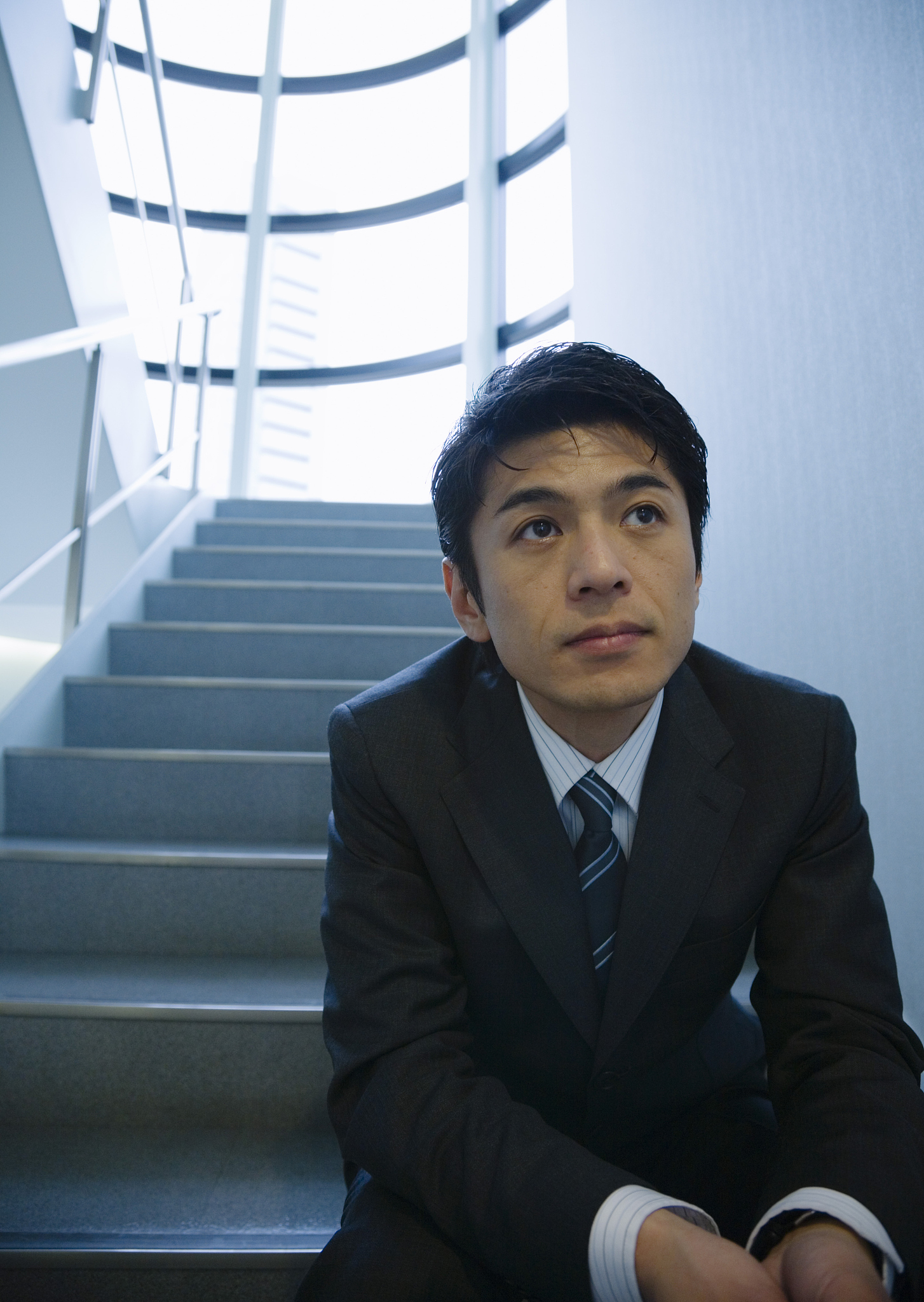 business man sitting on stairs