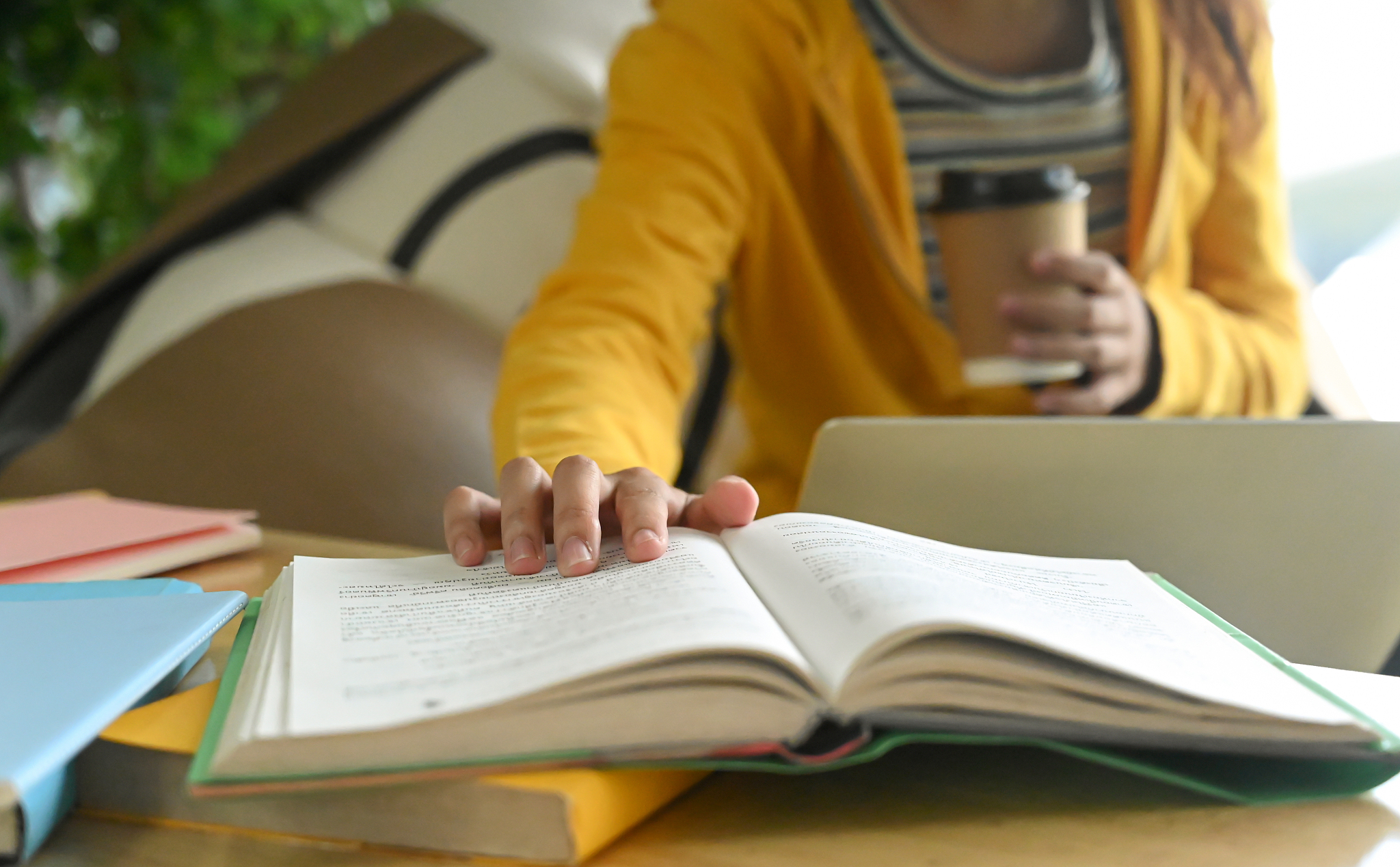 students are reading books and taking notes for exam preparation