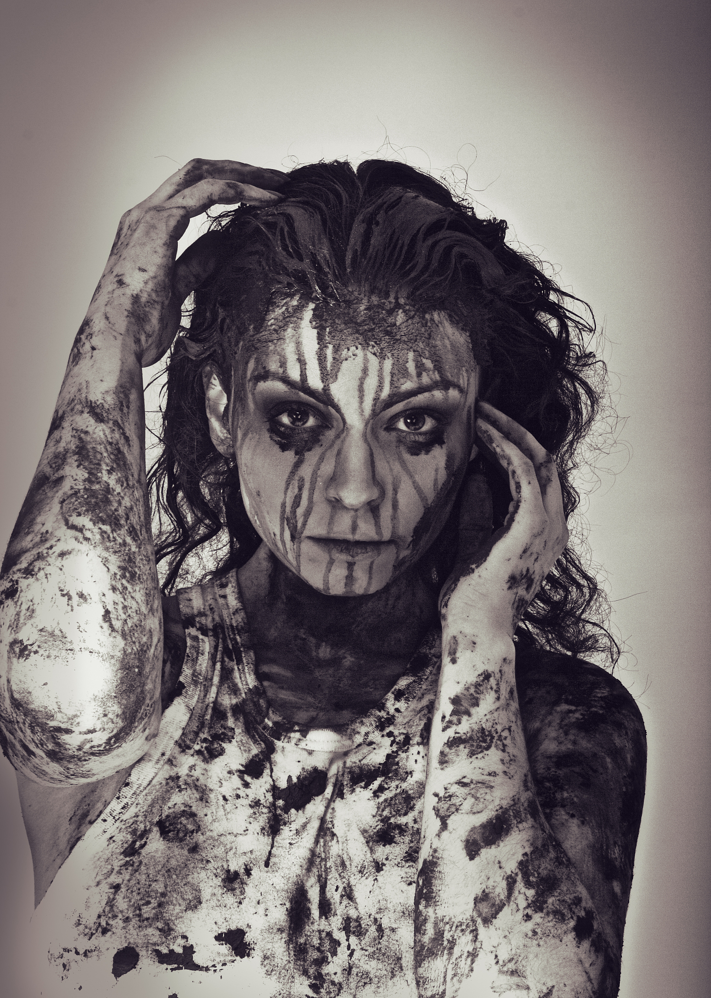 face and hands covered in mud