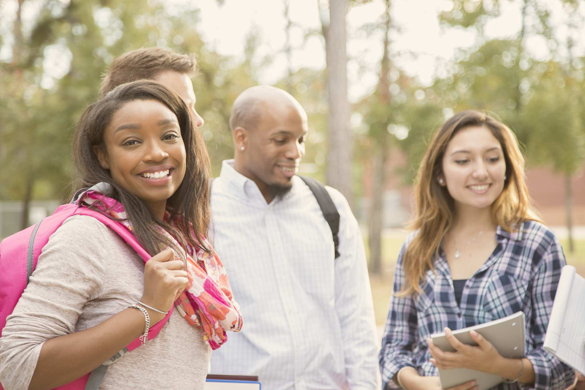 college student friends talk together on university campus.