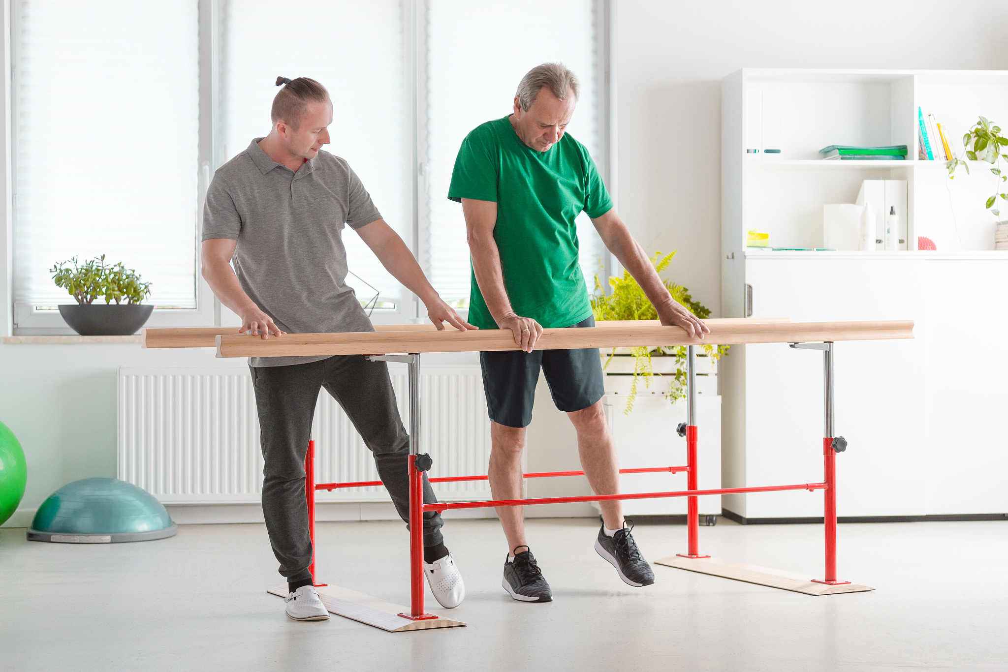 physical therapist excercising with senior man
