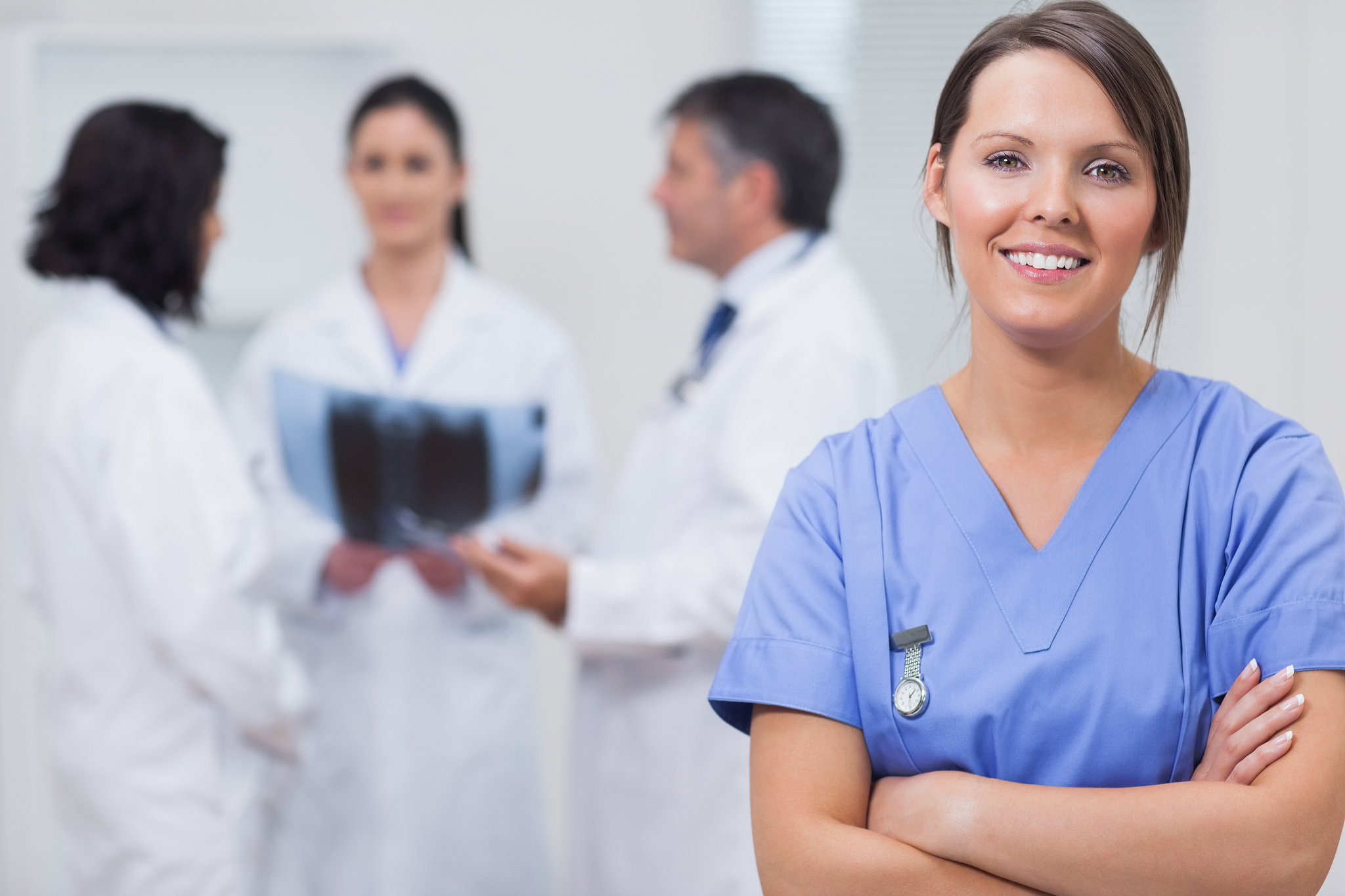 nurse smiling with her team taking xray seriously