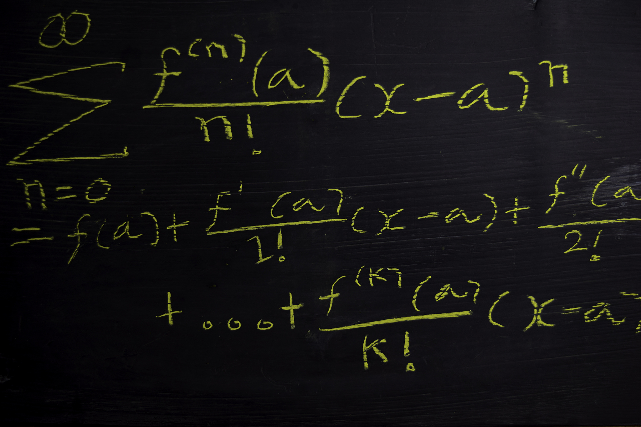 close up math formulas written on a blackboard. education concep