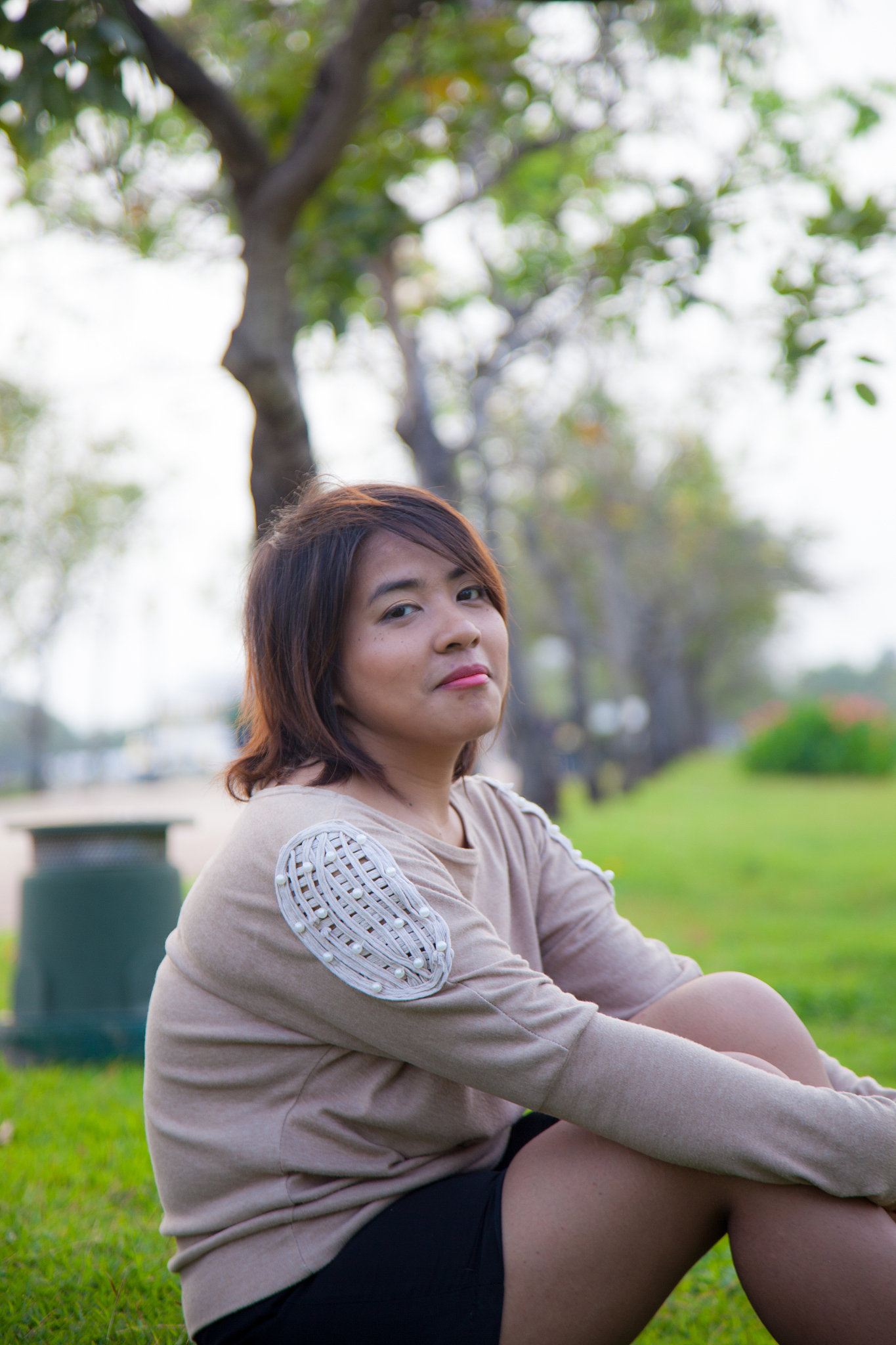 portrait asian woman sitting in the park.