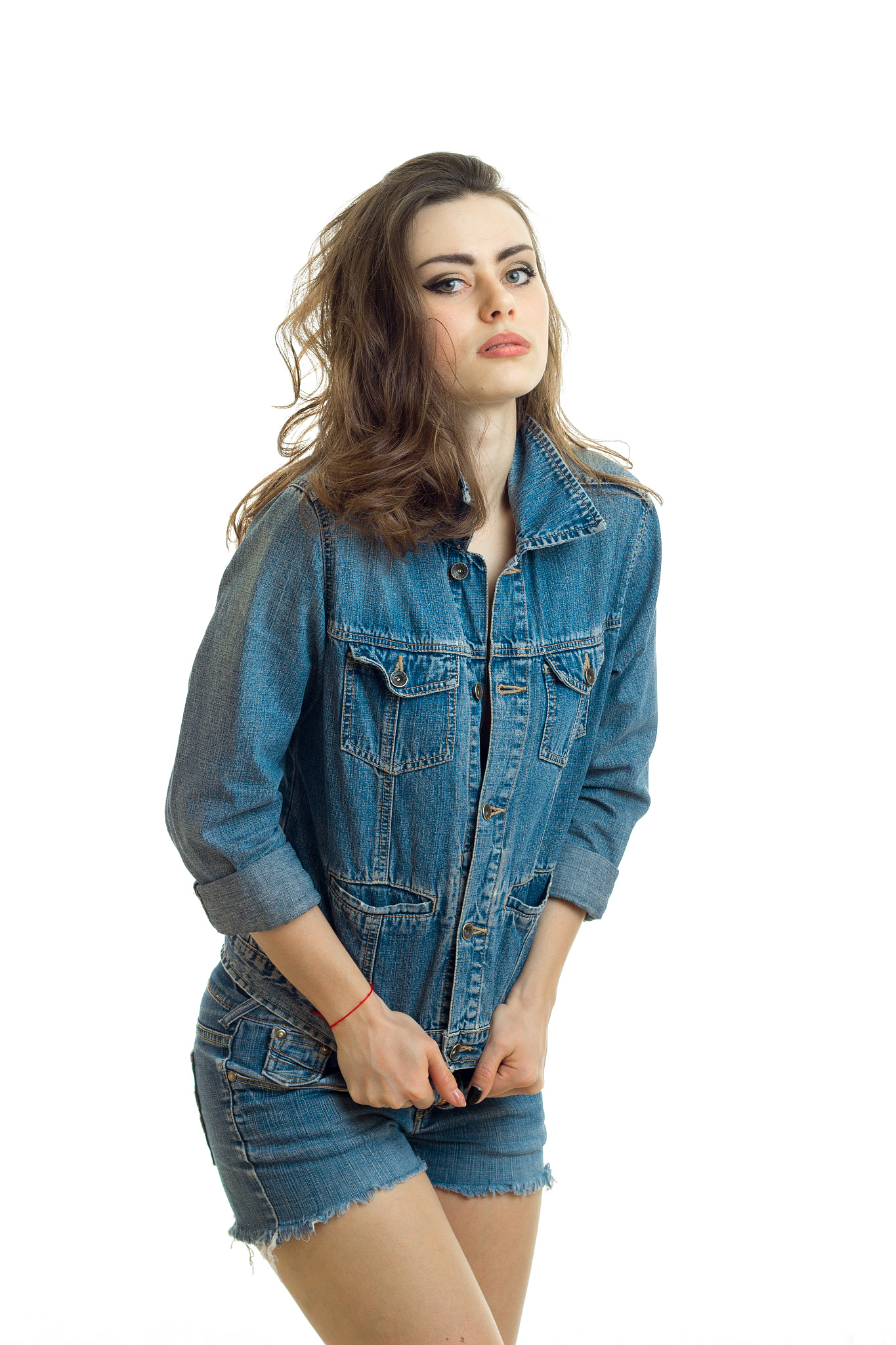 attractive young girl in jeans suit poses on camera