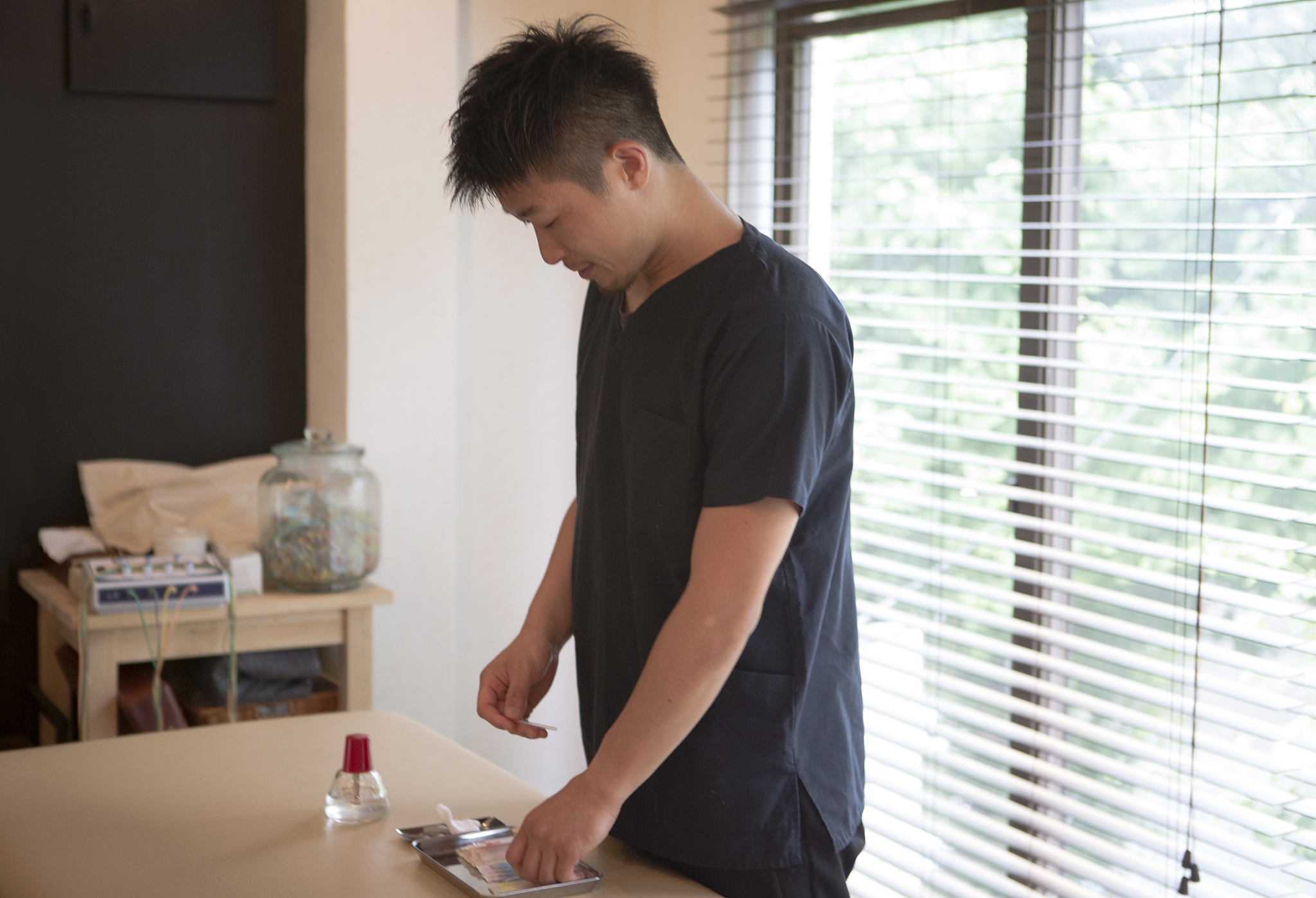 japanese medical person prepared for acupunture treatment in kyo