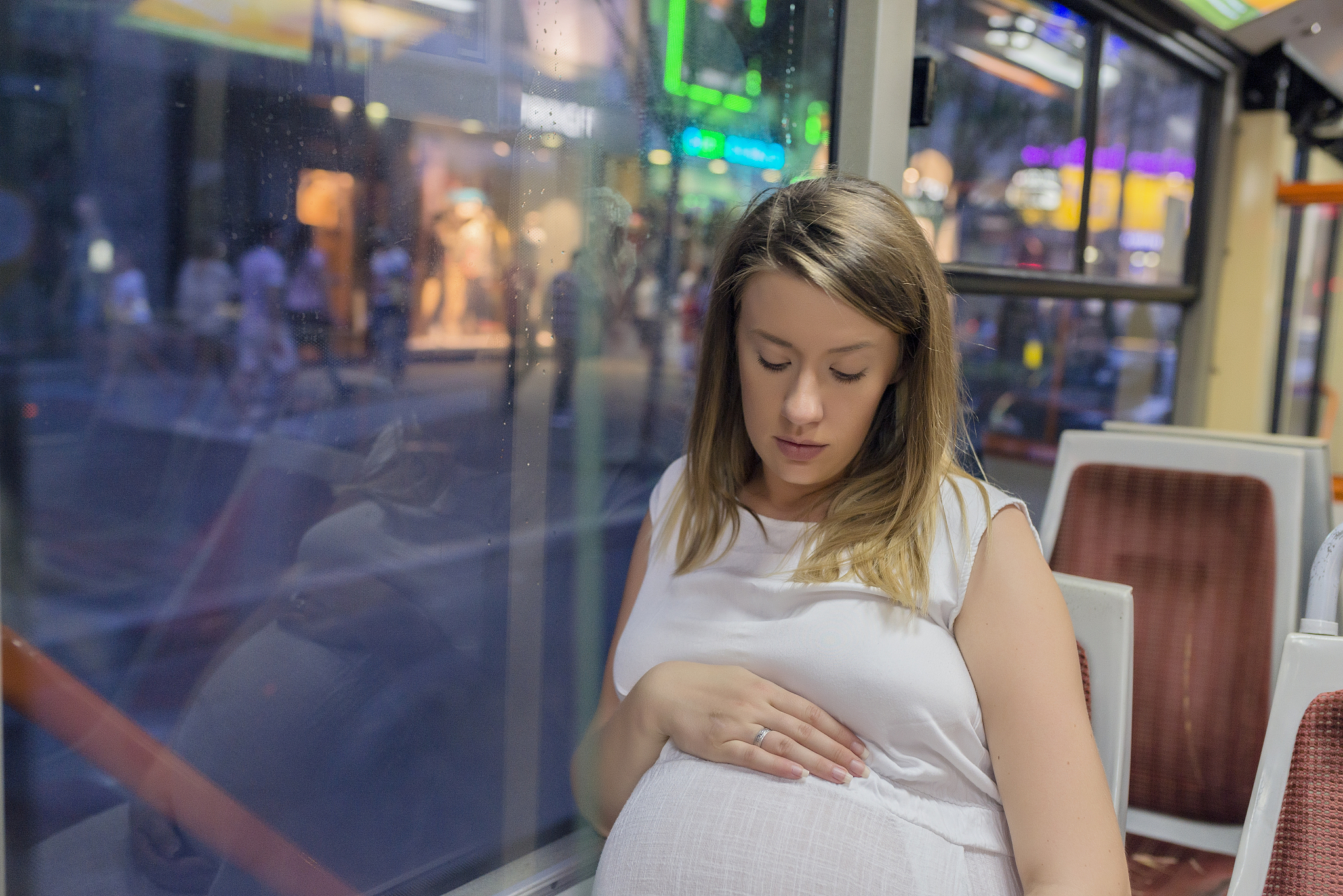 pregnant woman displeased in the bus