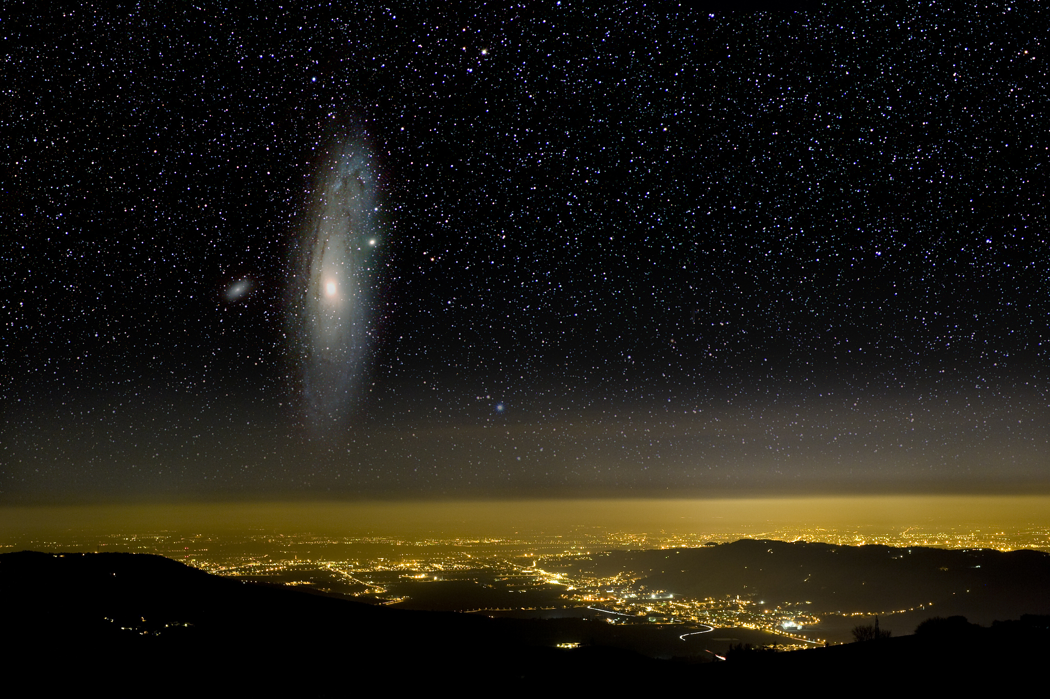 the universe above city lights. the andromeda galaxy.