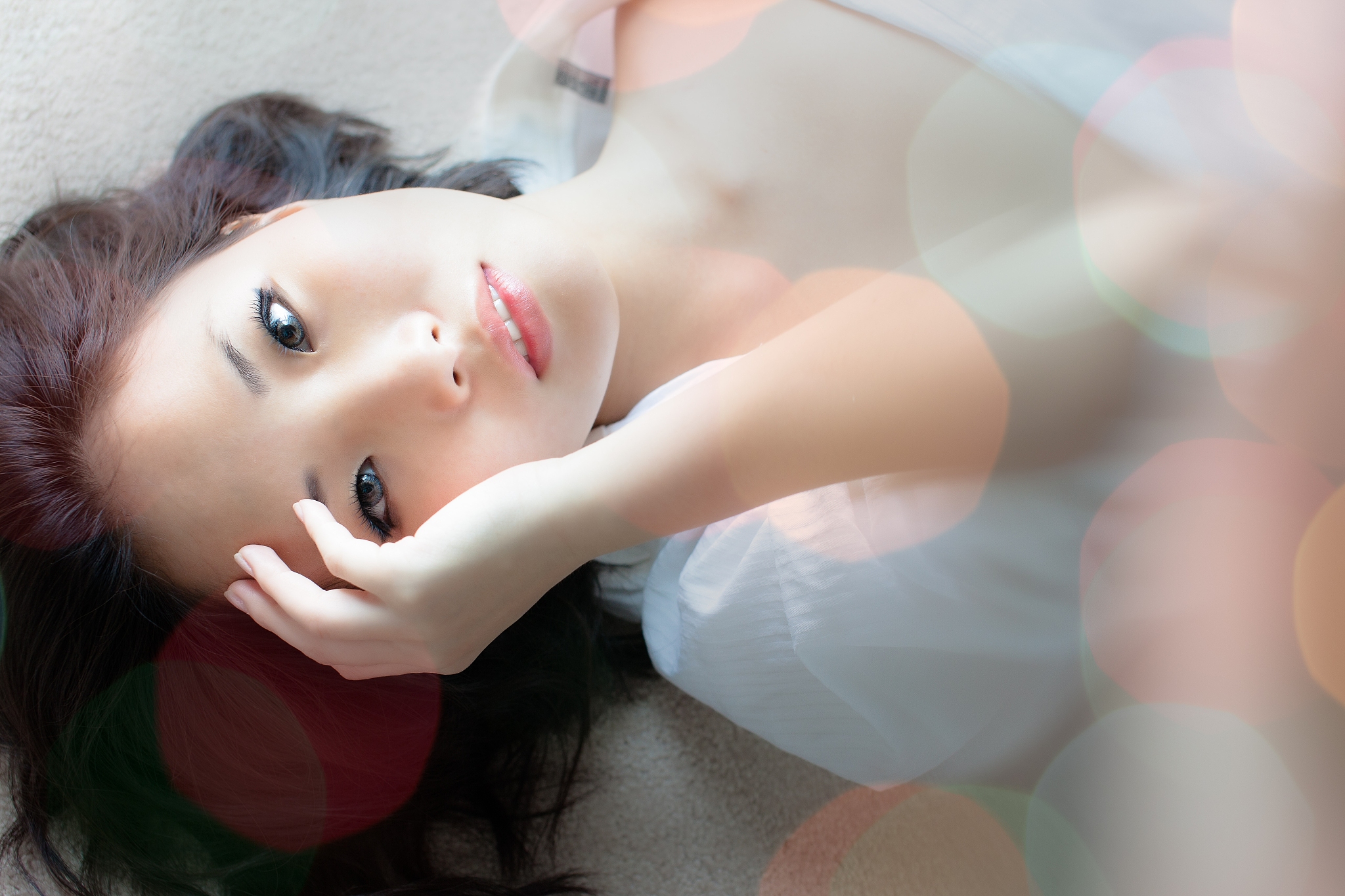 portrait of woman lying on back and looking at camera, canada