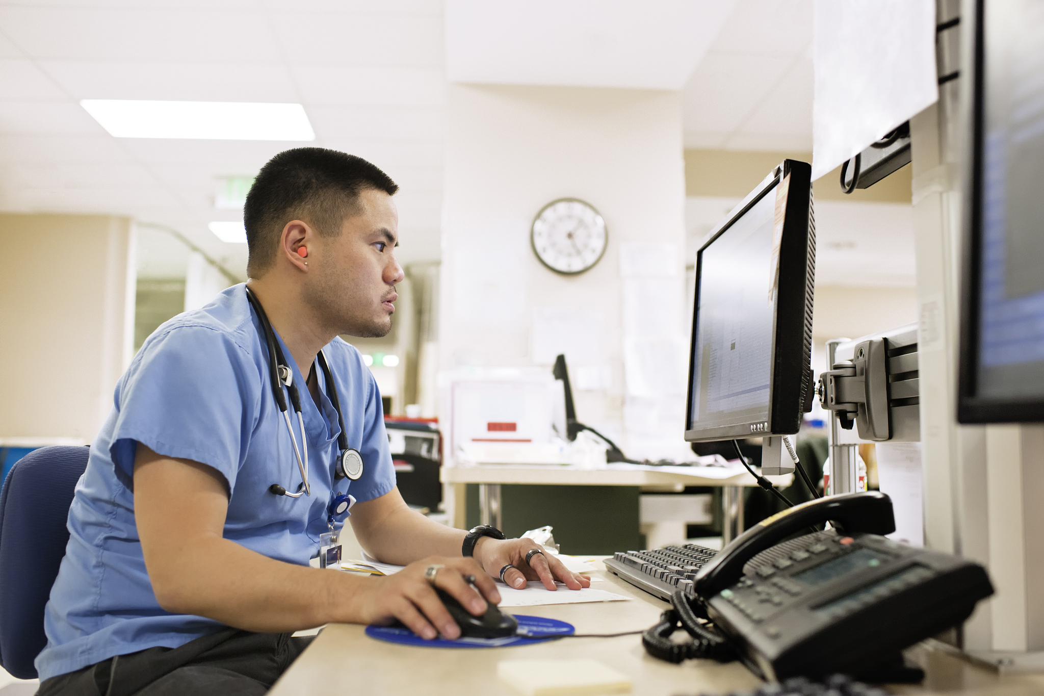 doctor checks computer monitor.