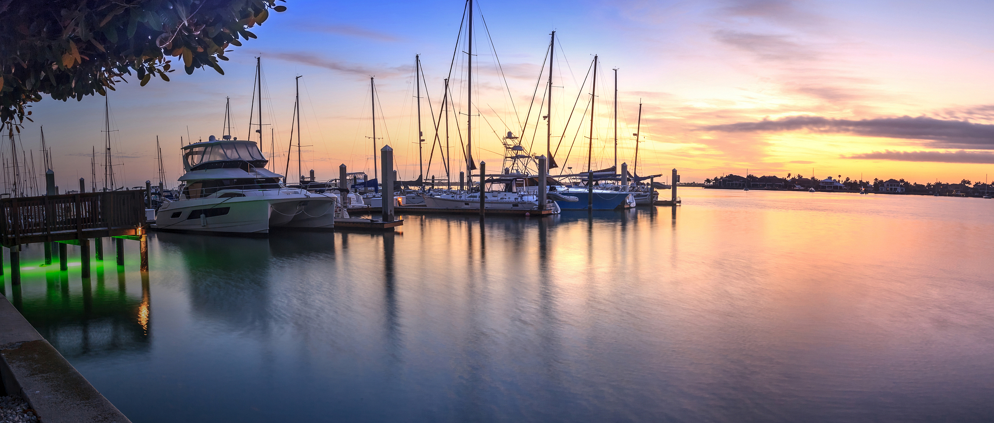 break of dawn sunrise over boats and sailboats at factory bay ma