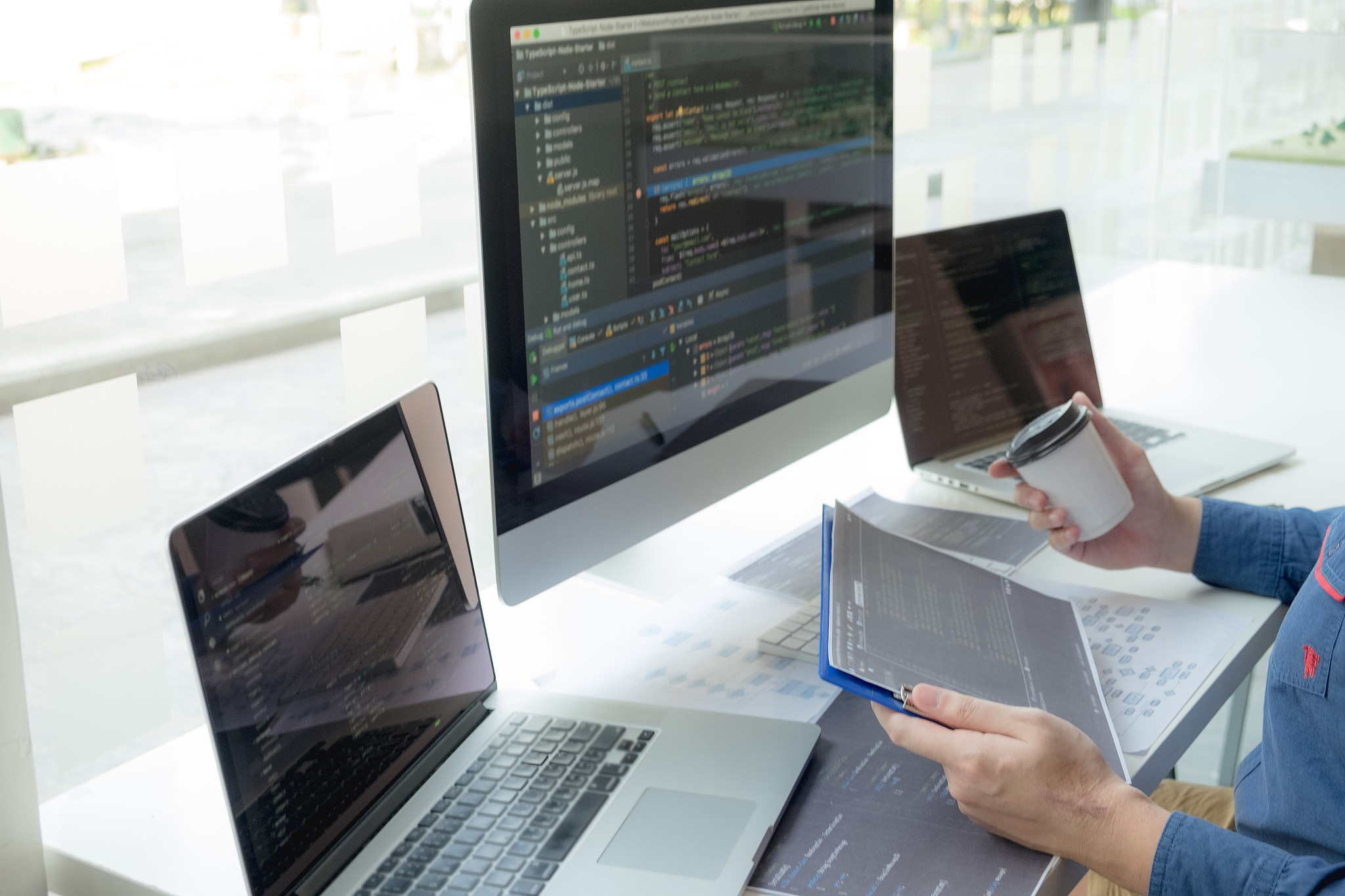 cropped hand of computer programmers brainstorming in office