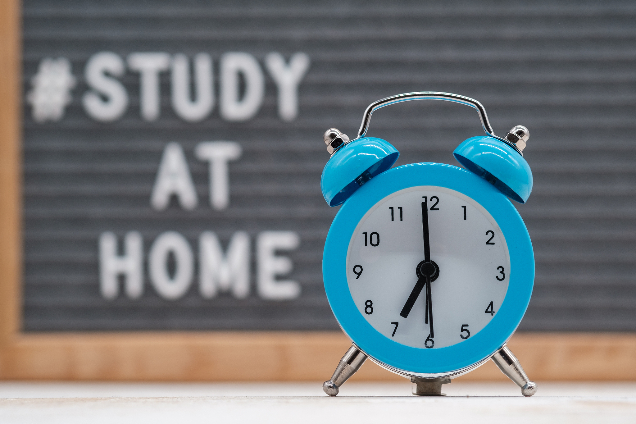 vintage analog alarm clock on the background of a blackboard wit