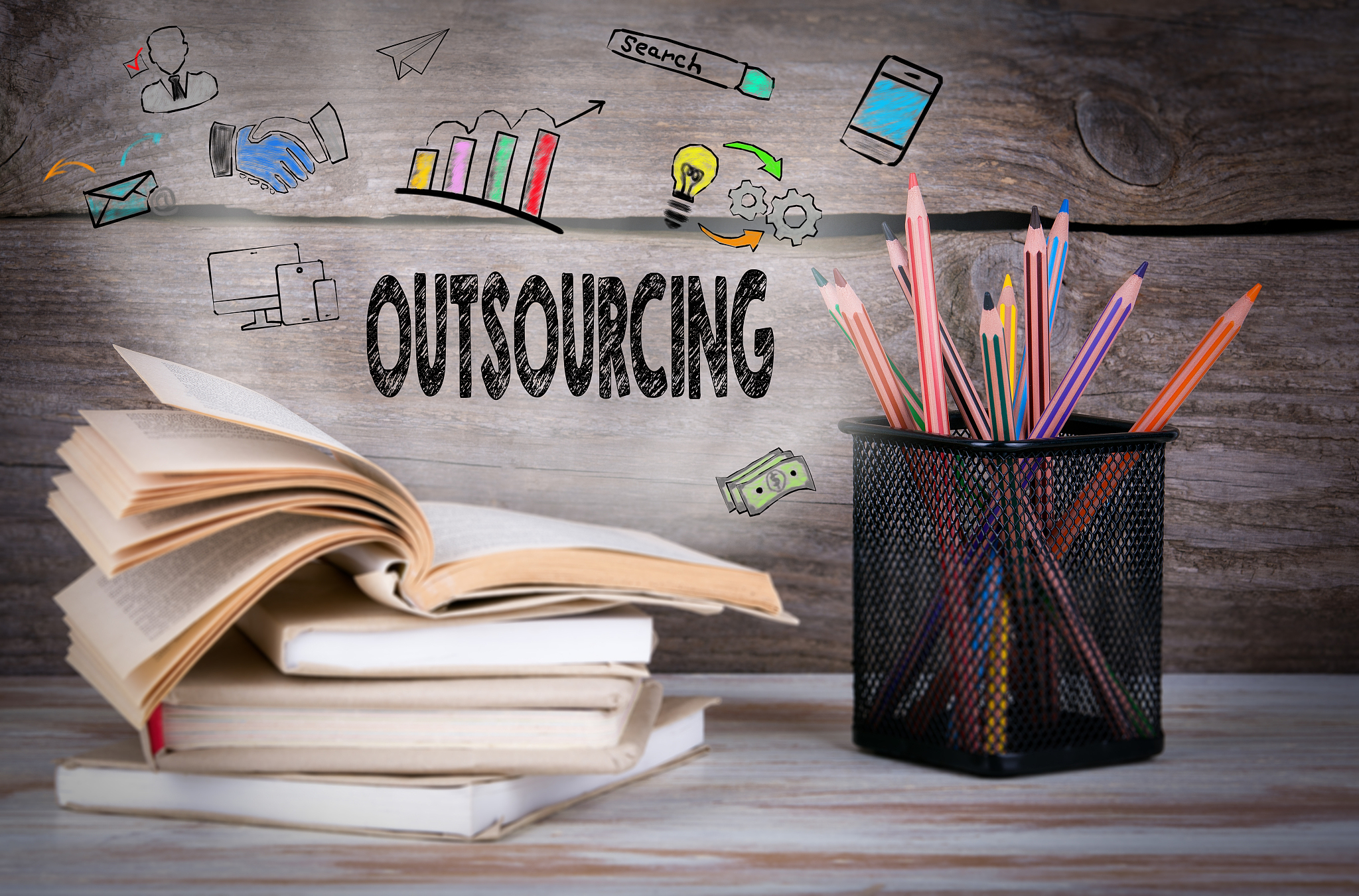 outsourcing, business concept. stack of books and pencils on the