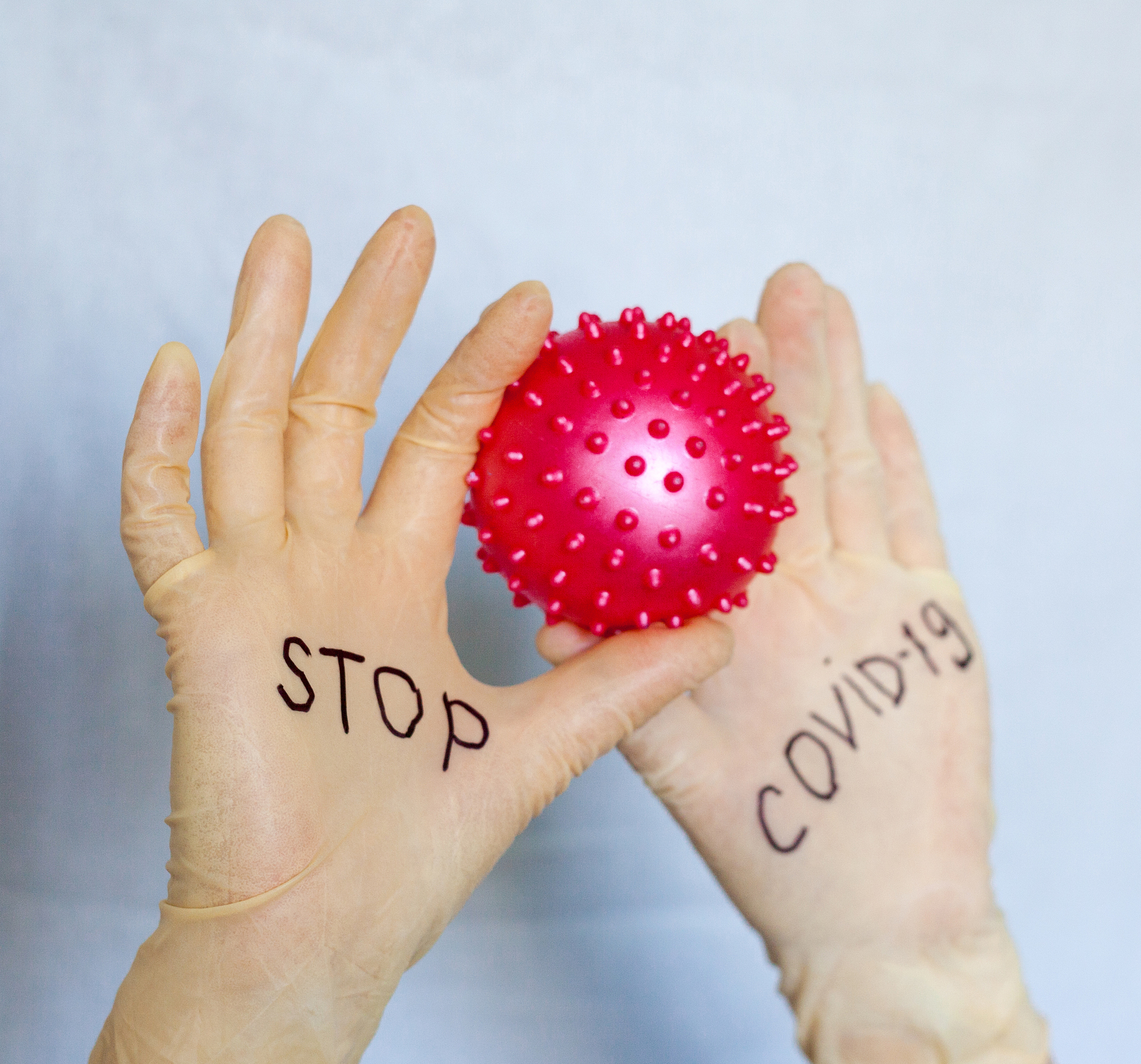 stop covid-19. text on medical gloves.
