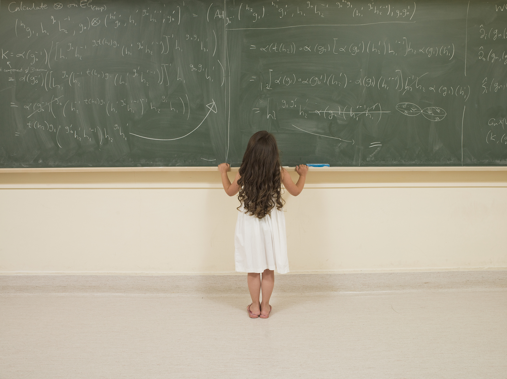 child prodigy looking at blackboard
