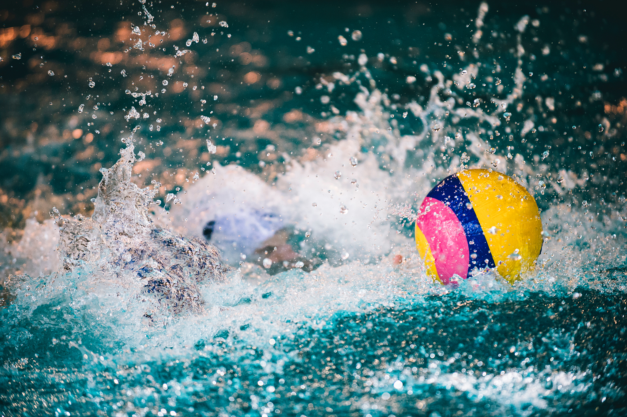 man splashing water in swimming pool