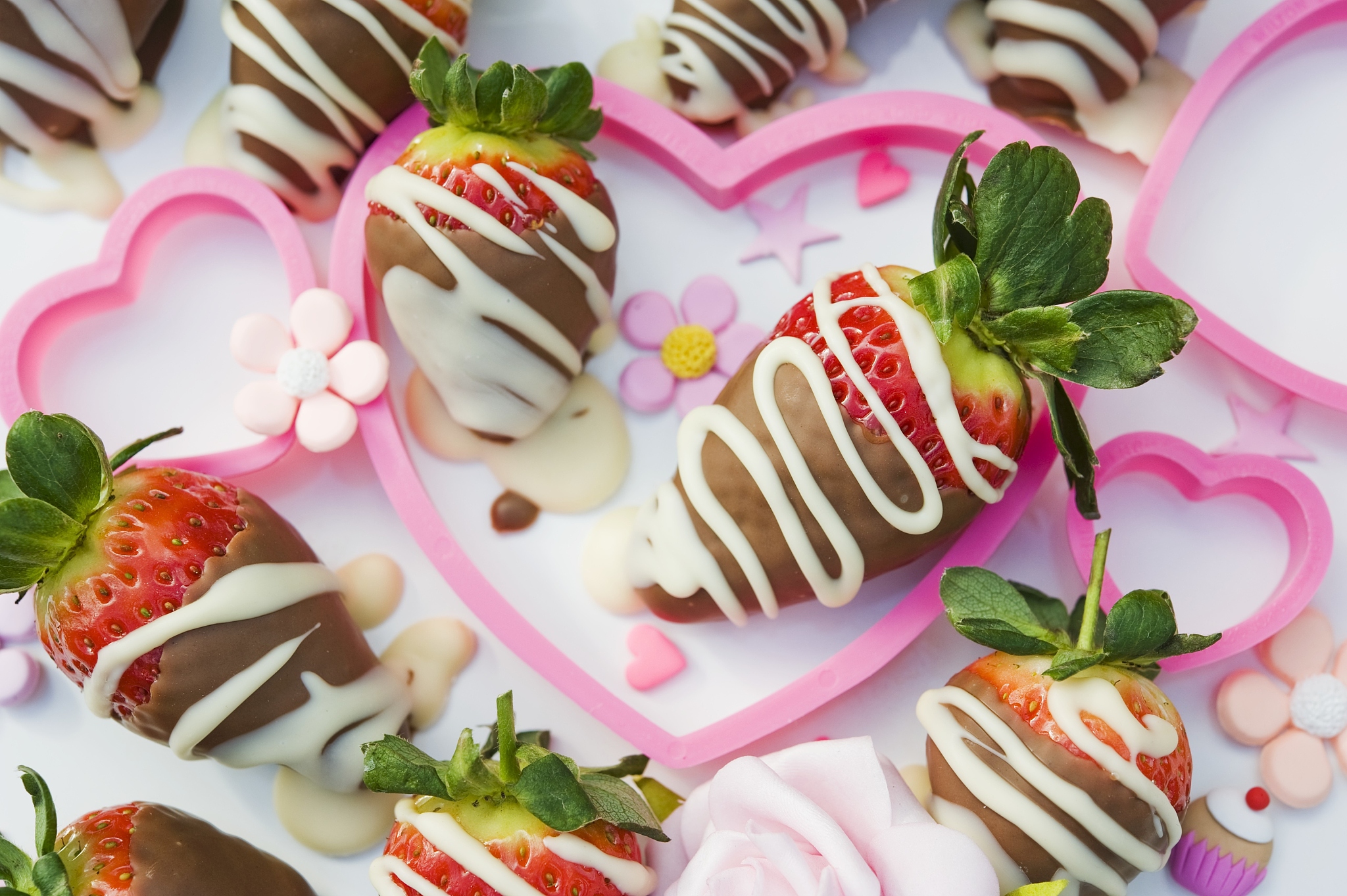 chocolate dipped strawberries in pink hearts with sugar flowers