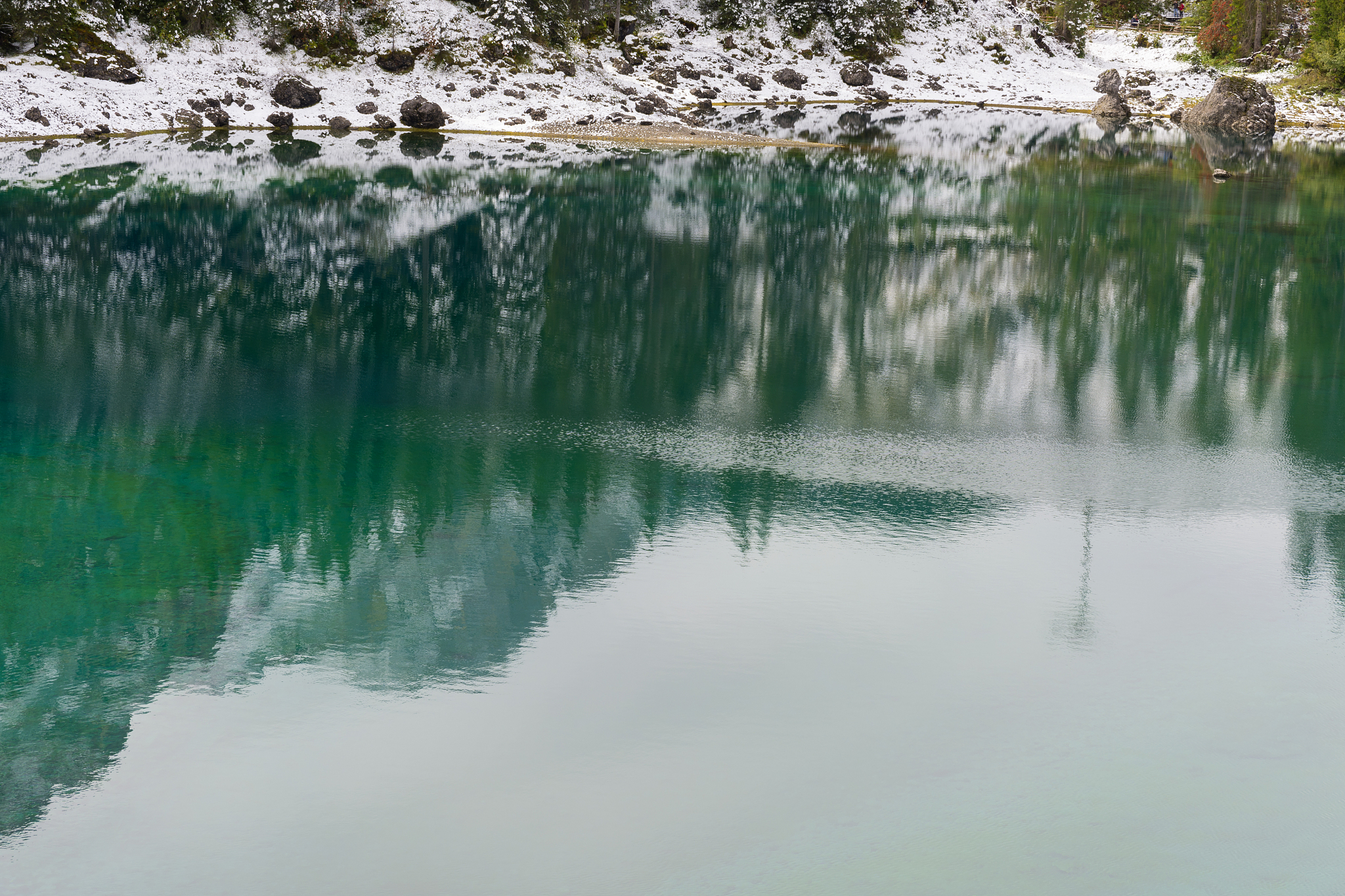 first snow on lake carezza in trentino alto adige
