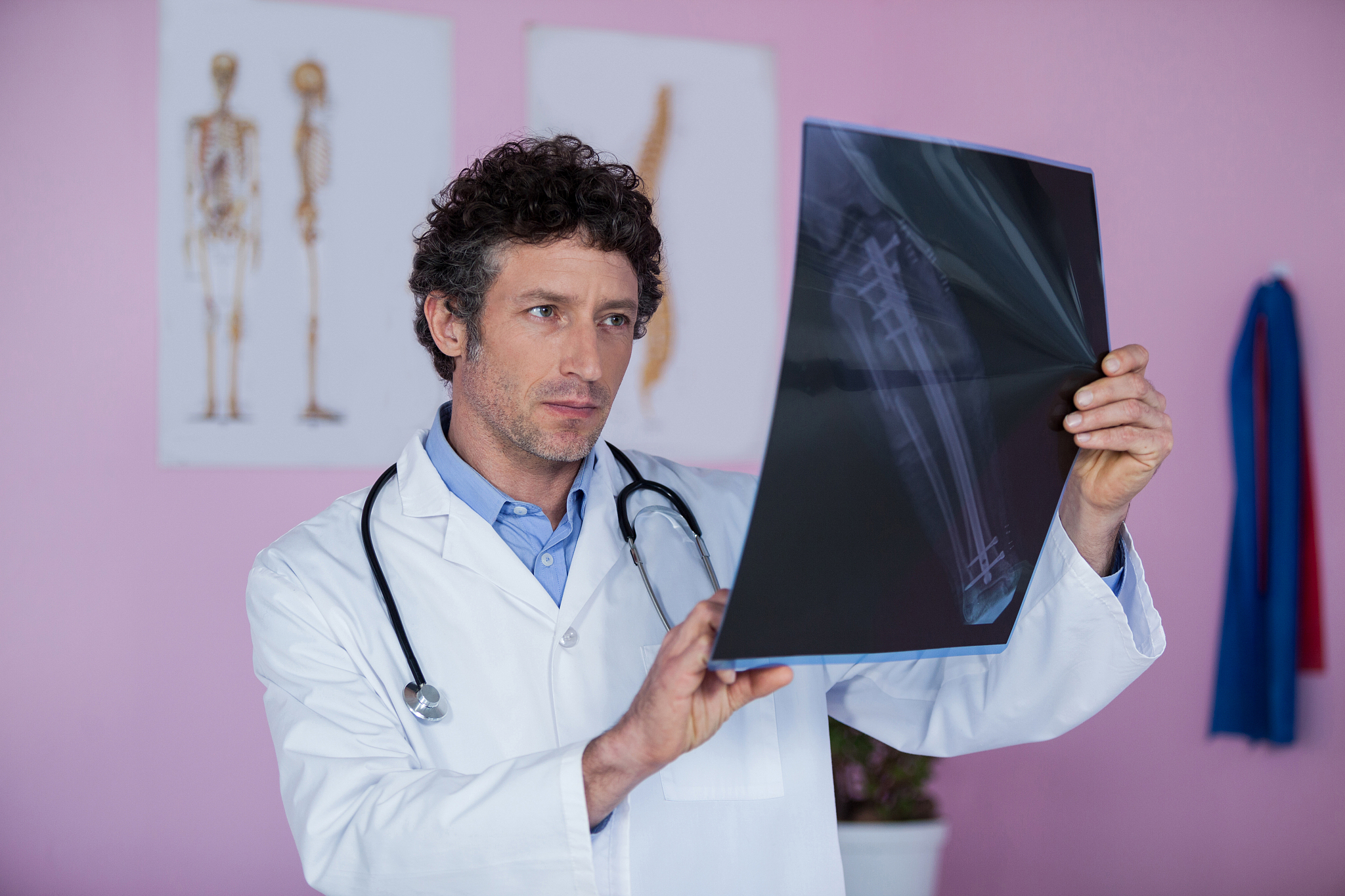 physiotherapist examining x-ray of patient