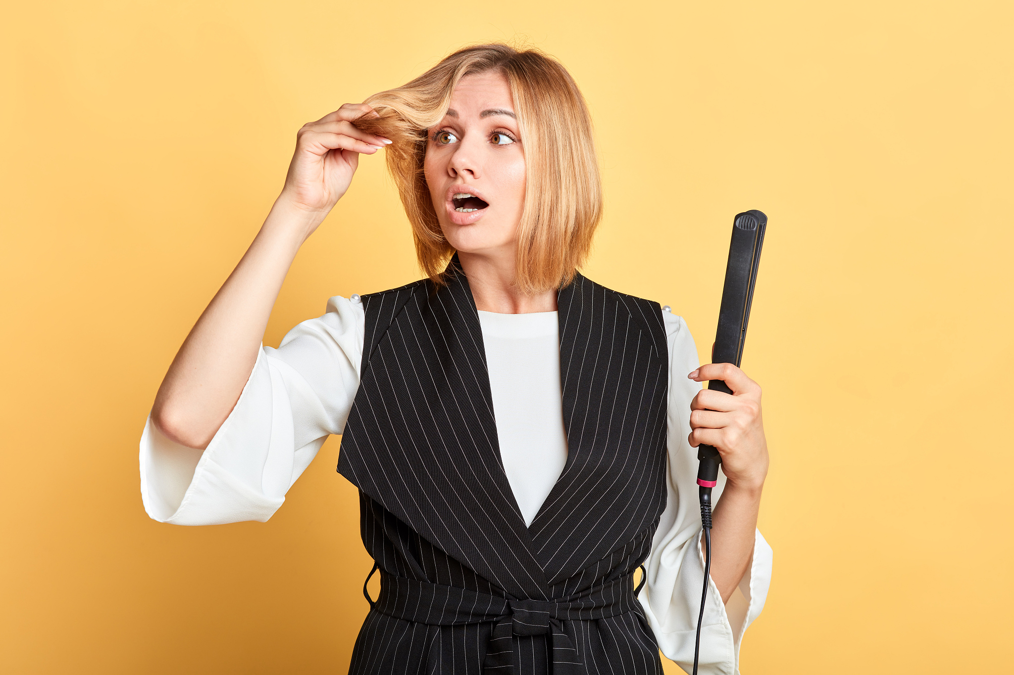 anxious woman with stylish haircut looks with upset expression a
