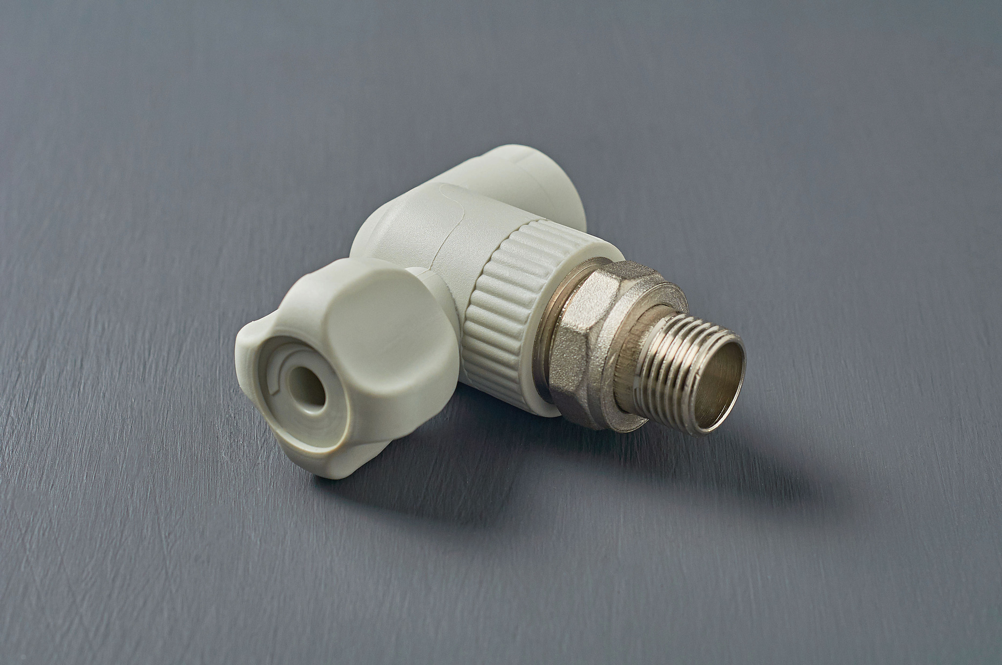 one polypropylene water faucet for heating radiator lies on dark