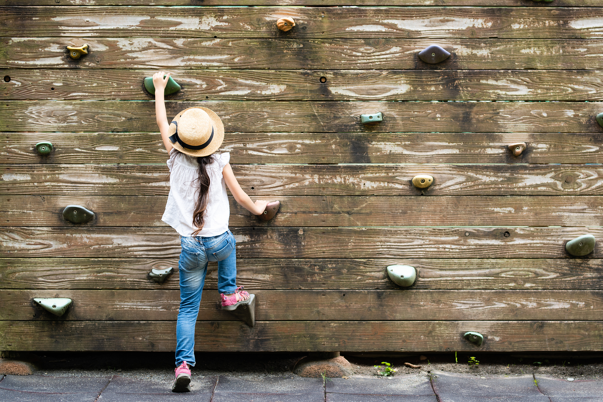 girl climbing a wall