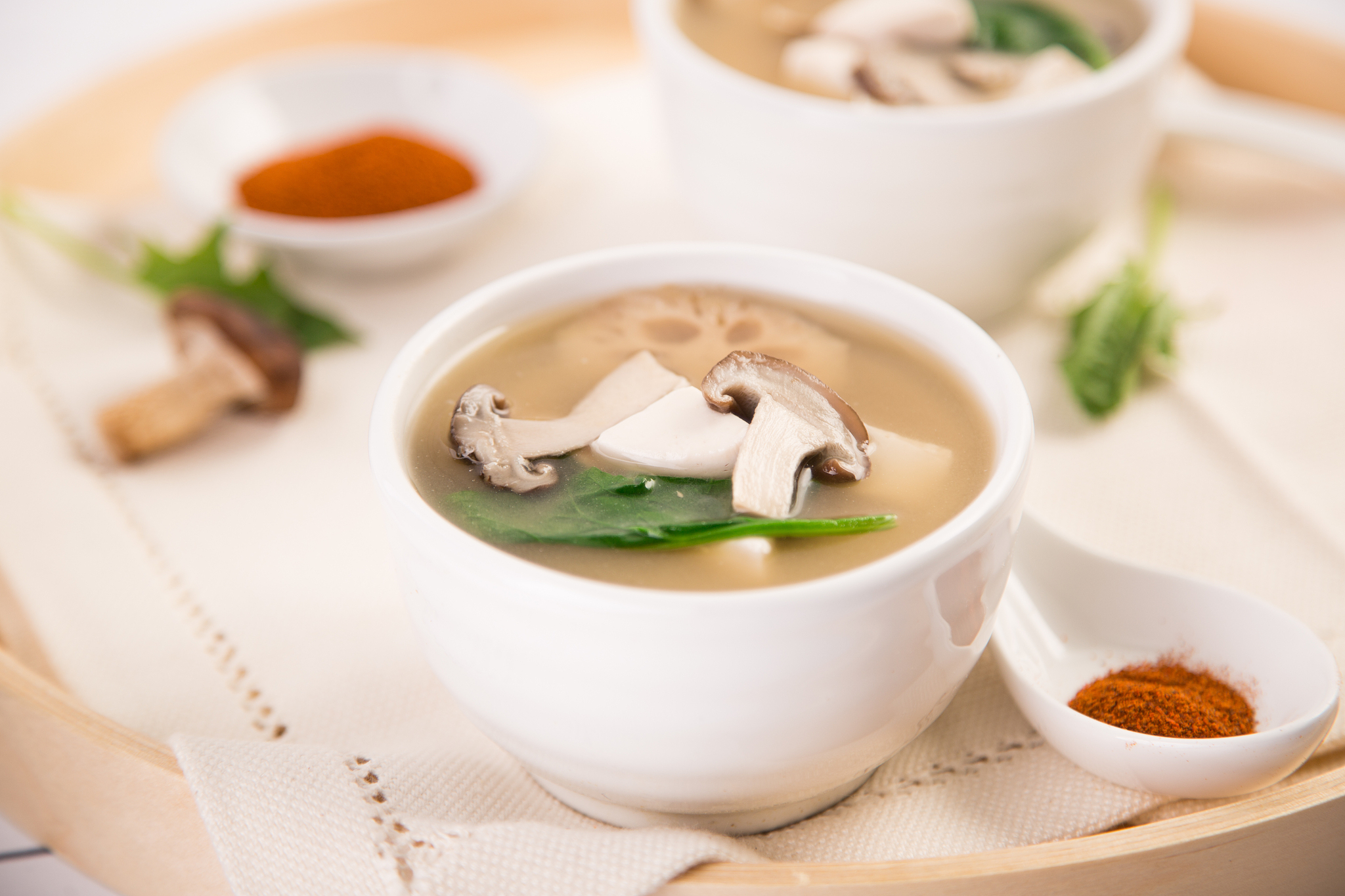 close-up of miso soup with mushrooms and tofu on table