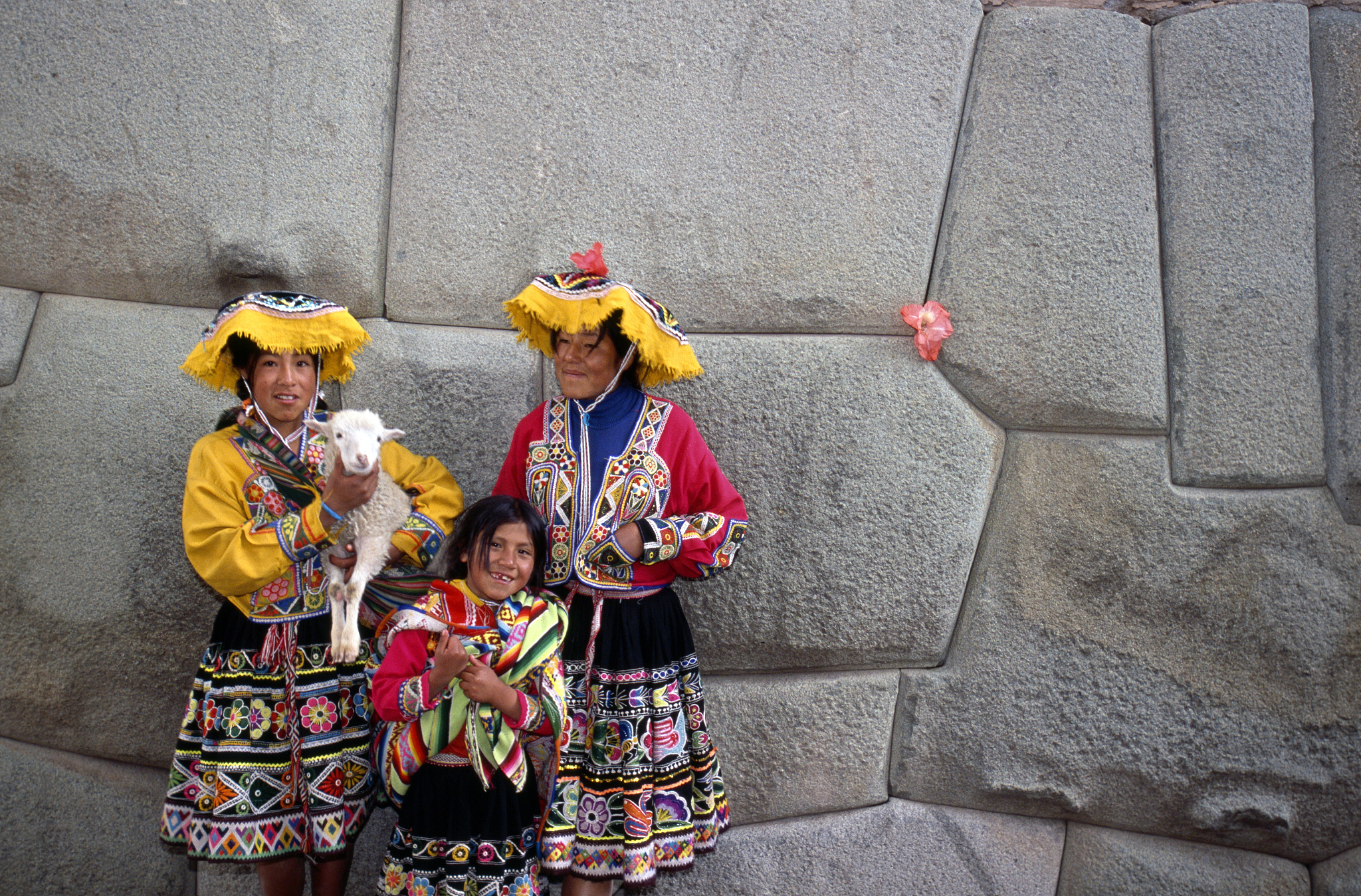 three sisters wearing traditional clothing