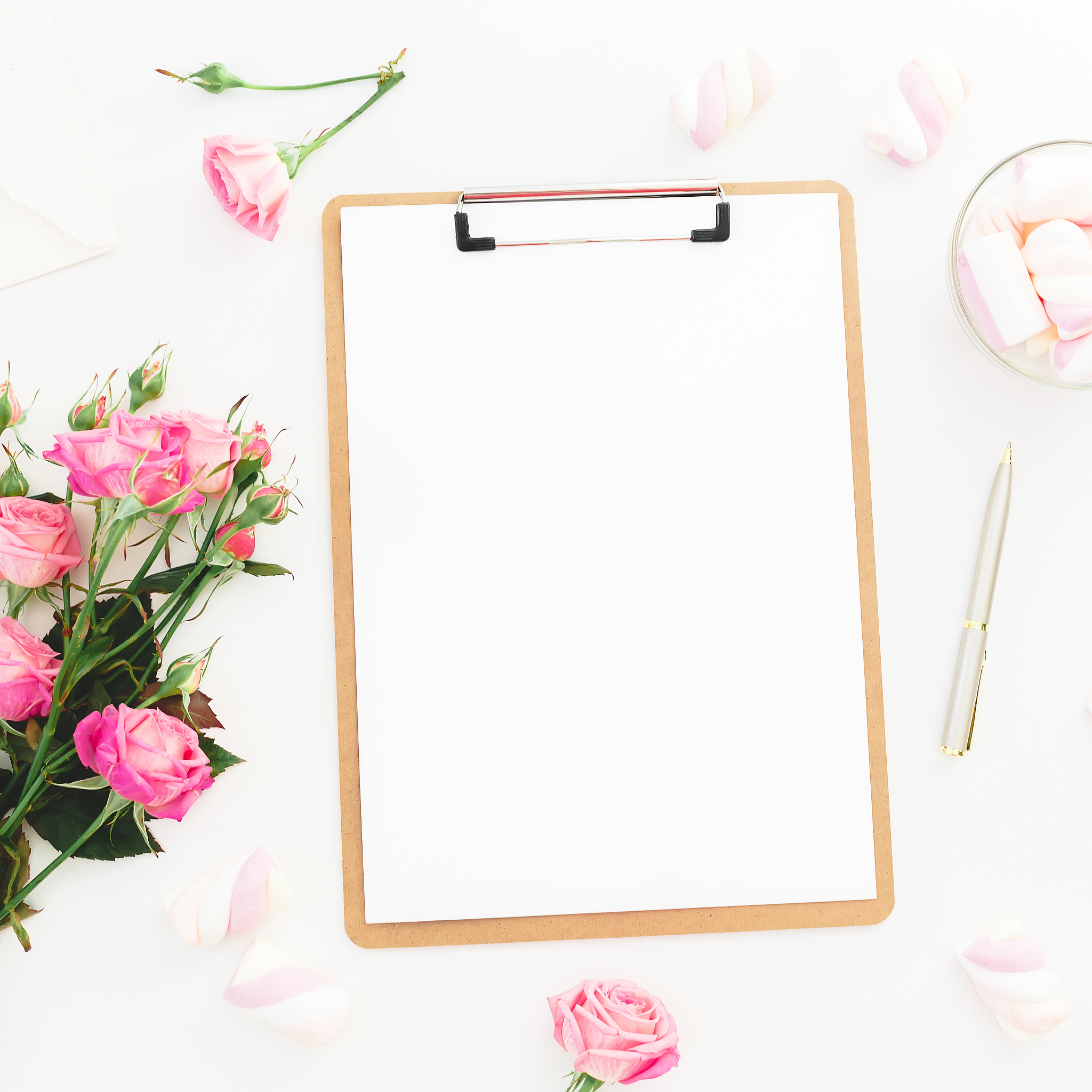 beauty composition with marshmallow, pink roses bouquet and clip