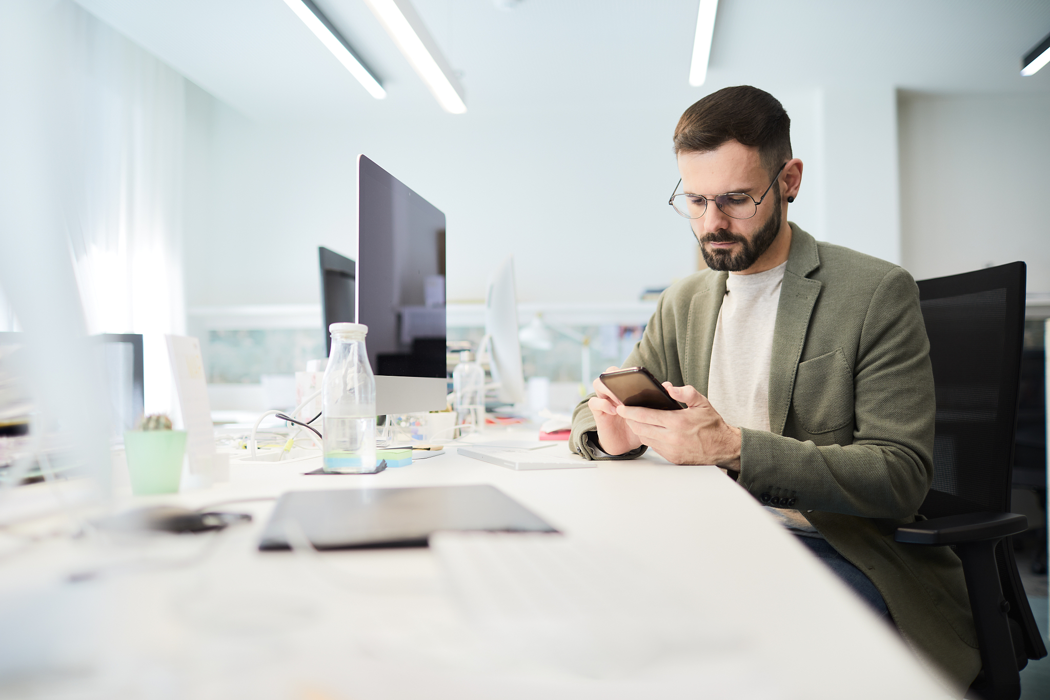 businessman working in an office and checking for messages on a 