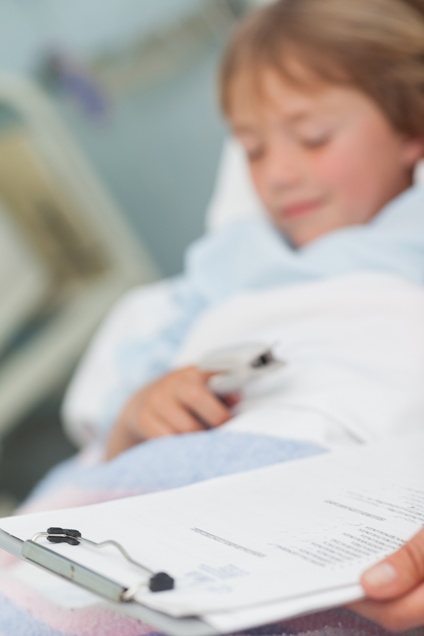 focus on medical result next to a child in hospital ward