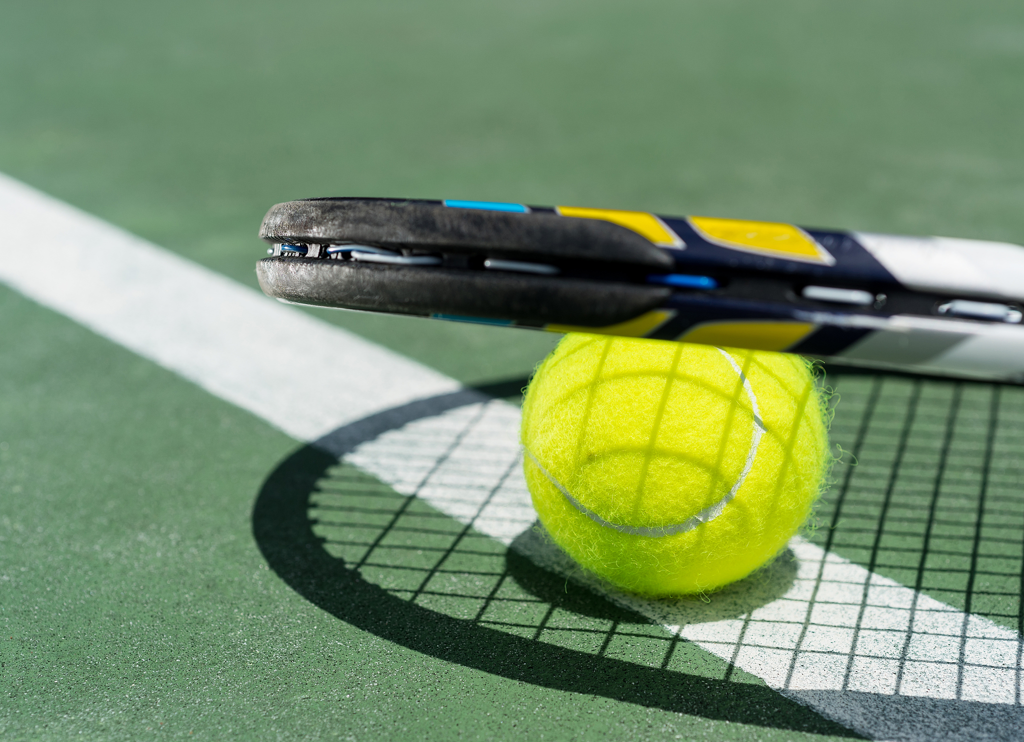 close up view of tennis racket and balls