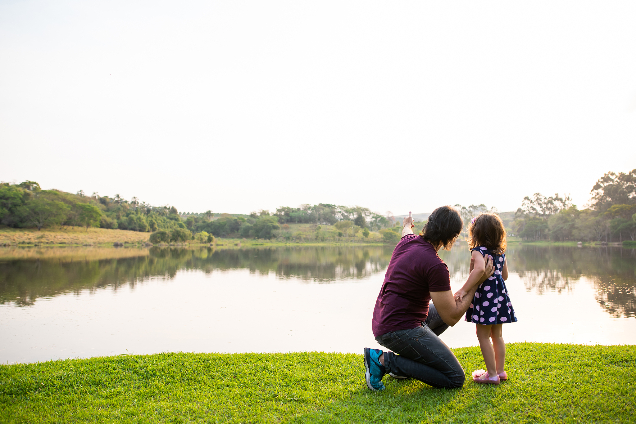 father and daughter at the lakeside in nature