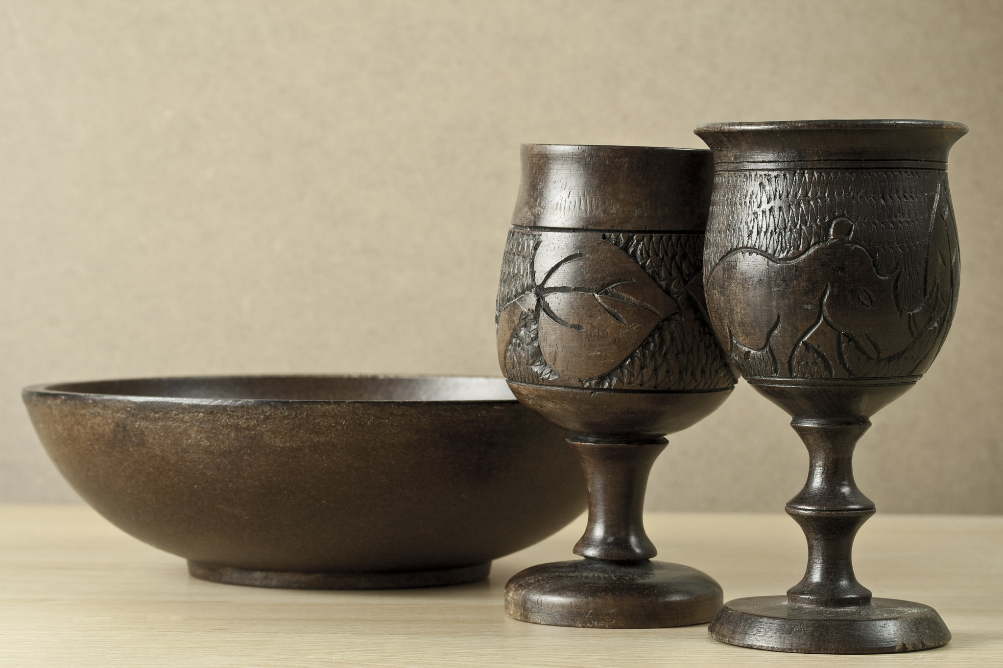 wooden cups and bowl on a neutral background