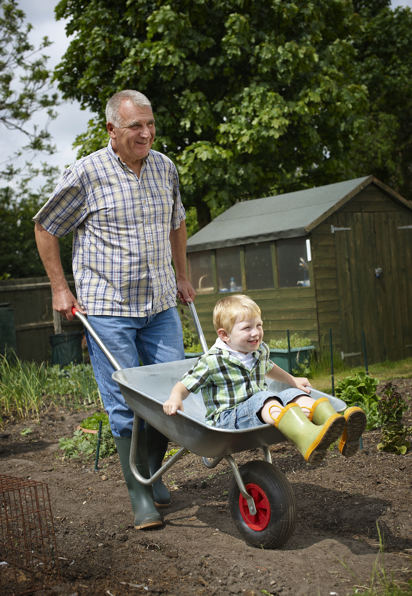 young boy being pushed in wheelbarrow