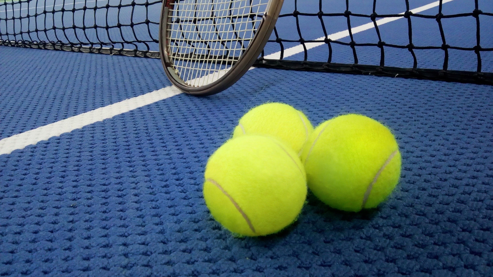 tennis balls on an indoor tennis court