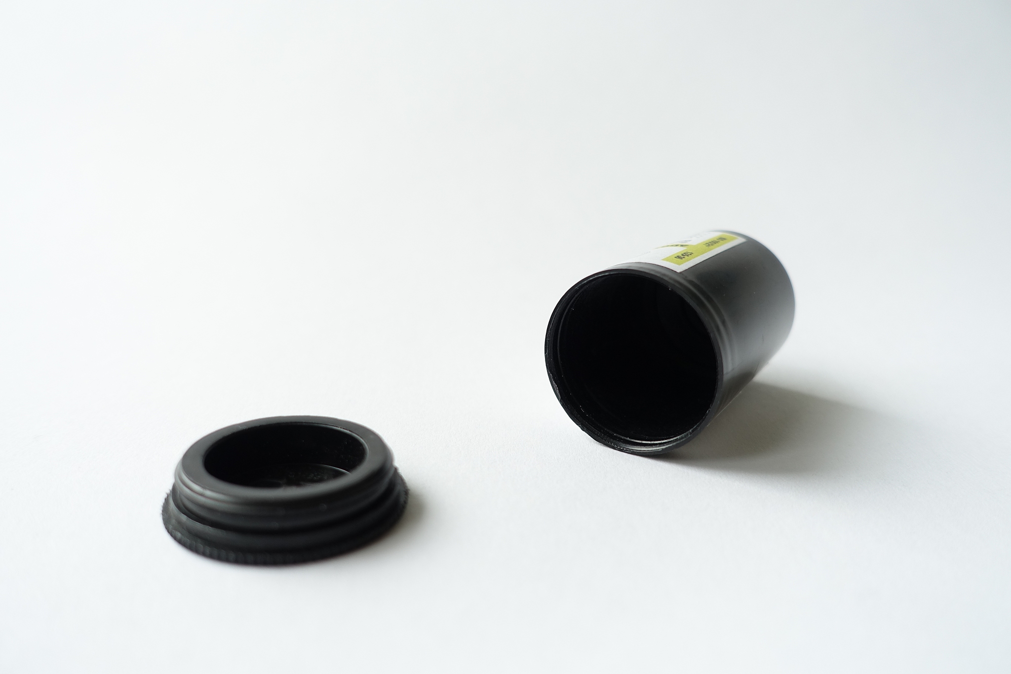 close-up of empty film canister on white table