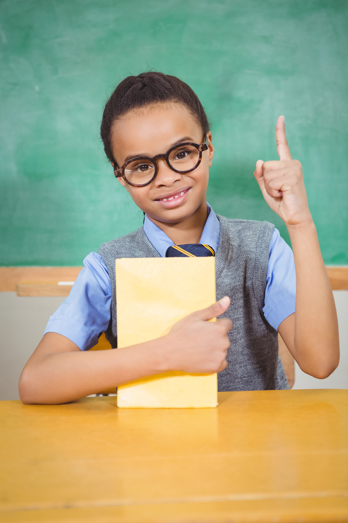 smart student raising hand to answer a question